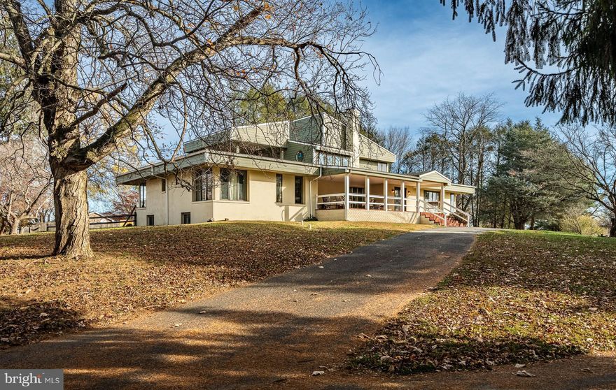 Tucked well off the road on top of a hill, the original stone cottage was built by a stone mason, Pasquale Scarpa, in the 1960's.  In 1988 the entire house was renovated, creating an open floor plan, enclosing the back porch to create an oversized kitchen with spacious breakfast room, adding the 2nd floor with more two bedrooms, full tile bathroom, TV room, and 2nd floor covered deck... The First floor was wrapped in windows to take in the view. Natural light floods the first floor with views from every room.  The upper deck has views of the sunset every night.  The Covered Brick front porch welcomes you to 763 Denton Hollow. The foyer has two closets. One set up with cubbies. Open floor plan. Vaulted ceilings. The two-sided Brick Fireplace enhances the spacious living room, dining room, great room. Gourmet eat in white kitchen with island. Granite counter tops. Light-filled breakfast room. The primary bedroom is wrapped in windows and has two walk in closets. Tiled master bathroom features a Soaking Tub and separate shower. Three additional guest bedrooms on this level.  The fouth bedroom has glass French doors . Presently used as an office. Updated White kitchen, with island, granite counters,  breakfast room with door to deck. Huge living room/dining room/ sitting room with vaulted ceilings 
Second level: Wide open oak staircase leads you to the 2nd level. Sitting area/ TV room, Covered 2nd level deck, 2 additional bedrooms and hall bathroom.   Finished walk out basement: Features a two bedroom, two bath guest suite with interior and exterior entrances. The guest suite its own laundry room/storage area and tile tile floors in walk out basement. Home was renovated in 2013 to including adding skylights, new roof, geo thermal heat/air added, new well, septic, many new windows. In 2019, the cedar siding was replaced with cement siding.  The property has a four-stall barn, fenced pasture, and run-in shed. Bring your livestock.  Come enjoy the tranquility, and views.