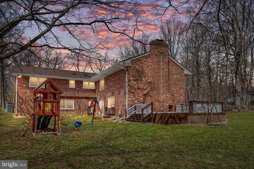 Magnificent All Brick Rambler Perfect for the Entertainer!  This home has it all!   Formal Living Room with Gorgeous Brick Fireplace.  The Formal Living and Dining Rooms have Crown Molding  and Sparkling Wood Floors.  The Sunny Gourmet Kitchen offers a Huge Granite Island, Granite Counters and Tile Backsplash, Plenty of Cabinet Space, Double Wall Ovens, Cook top, Wine and Beer Fridge, Sleek Stainless and Black Appliances and Recessed Lighting.  The Kitchen has an Overlook to the Lodge Like Great Room with Incredible Cathedral Ceiling, Rappahannock River Rock Waterfall and Wall, Massive Brick Hearth with Wood Stove, Gorgeous Wood Mantel and Built In Firewood Storage.  There is also a Large Office/Den Space and a Half Bath on the Main Level.  The Spacious Master Suite has a Gorgeous Stone Fireplace that is Wood Burning or use the Convenient Electric Logs, Huge Walk In Closet with Closet System.  There is a Beautiful Glass and Tile Shower Enclosure,  Double Sinks and Linen Closet  in the Master Bath.   There are 2 Additional Spacious Bedrooms with Large Closets with Interior Light.  The 2 additional bedrooms share a Full Bath with Tile Floor and Granite Counter.  Plenty of Room and Amenities for Outdoor Entertaining!  The Deck and Hot Tub Overlook the Pristine Woods.  Gather Everyone around the Built In Fireplace on the Deck on a Cool Spring Night.  There is a 2 Car Multi Level Garage with Air Compressor, Unfinished Storage Space with Lighting  in the Loft Above, Craftsman Wireless Garage Opener, Benches and Cabinets in Main Level Garage.  There are 2 Chicken Coops with a Shed.  An Additional Large Storage Shed for Lawn Tools and Equipment.  The Playground Set can Stay too!  Pecan, Plum, Cherry,  Persimmon , Hickory Nut and Fig Trees Create Your Own Orchard.  The Priceless Memories are Yours to Make at this Amazing Home!  The Roof is Just 6 years Old,  Trane HVAC (7 Years Old) ,  New Water Heater,  Windows were replaced 10 Years Ago with Dual Pane Argon Gas Pella Windows,  Water Treatment System, Whole House Humidifier and New Carpet.