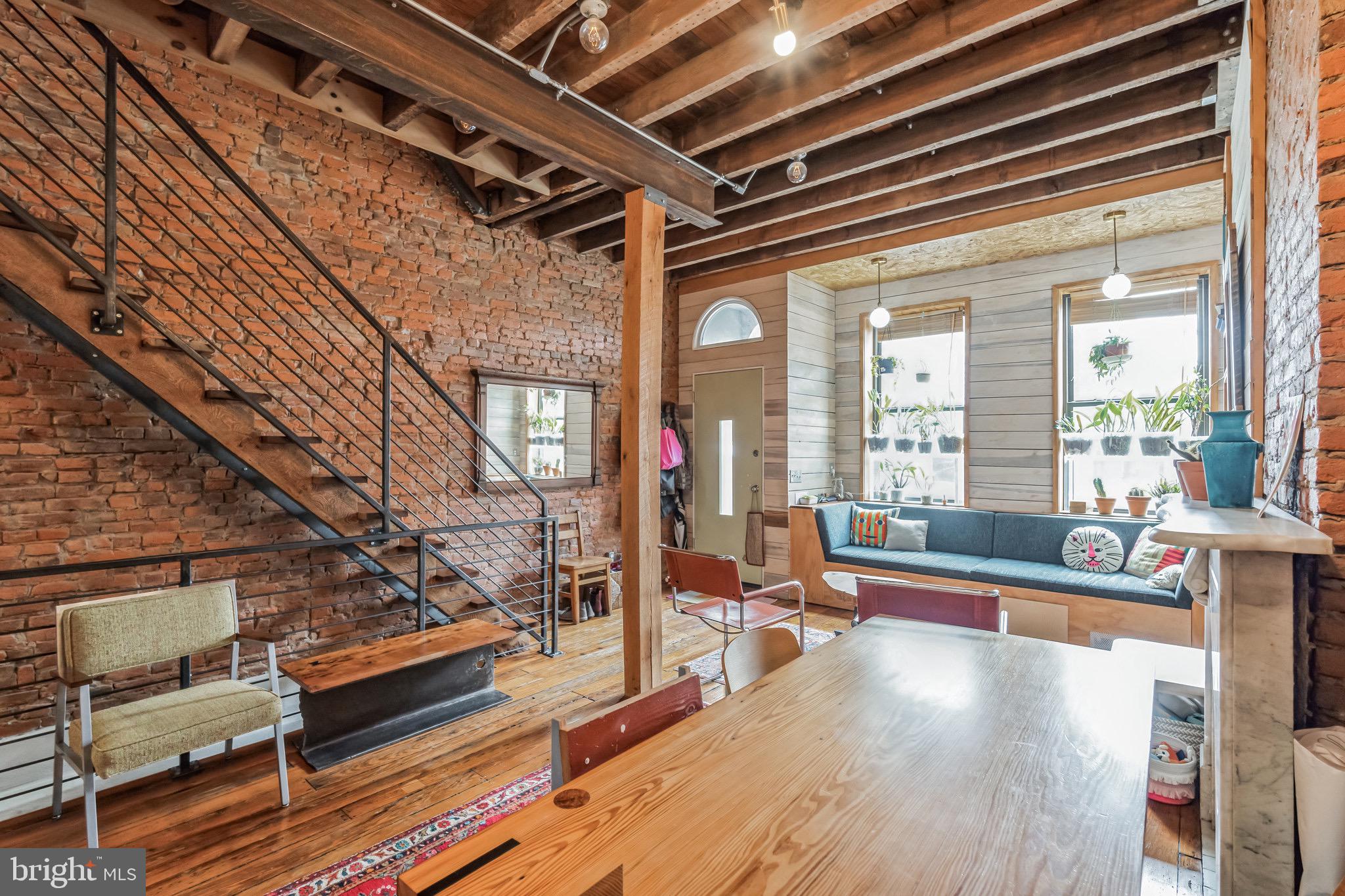 HERE’S A STUNNER: The personal family home of Philadelphia's celebrated design/build firm, Craftwork Home. This is a large 1880's rowhouse transformed into an architectural gem - where old and new come together for a showpiece of craft and comfort. The home is 2,000 sq.ft with 3 Bedrooms, 2 Full Baths, A/C, gorgeous old-growth wood floors, an extra den plus 2 dining areas and a lovely backyard. This home is among the greatest hits of East Kensington/Fishtown Architecture and can be your next place to call home. House is a short walk to Frankford Avenue, great coffee, vintage shops, and some of the best food & music in the City. The EL train is a few blocks away for quick access to Center City. 1ST FLOOR: Enter from set-back vestibule outside into a gorgeous space of warm wood, industrial steel, red brick, colorful fabrics, and great lighting. In the front: a built-in window seat for napping or reading surrounded by custom bookcases and nooks for plants. The original 19th Century mantlepiece sets the stage for entertaining, working or relaxing, and opens into the larger of 2 dining areas. Middle of second floor features more custom cabinetry and millwork transitioning to an inspiring kitchen. KITCHEN: Center island is surrounded by custom cabinetry, concrete counters, multiple nooks, stainless appliances, and a large chef’s gas range. On the left there are triple windows and river-rock accent at the floor. To the rear of the kitchen area - more built in storage and a 2nd dining area - framed by a large glass door overlooking the yard/garden. OUTSIDE: Large deck leads down to an open area large enough for grilling, entertaining and gardening, complete with mature trees and plantings. 2ND FLOOR: Front Bedroom (1 of 3) has two south facing windows and built-in oak closet/storage. 2nd Floor Middle is an open den - perfect for movies, reading, and conversations. In the middle of 2nd Floor is the hallway bath, with custom shower, concrete sink and dozens of special details. 2nd Floor Rear: Bedroom 2 is the primary suite with a large picture window overlooking the garden, light on two side of the room and more custom woodwork/storage. 3RD FLOOR: Front Bedroom (3 of 3) is spacious, has superb natural light, great closet space and a custom mural from a local artist. 3rd Floor Rear is the 2nd full bathroom - this time with tub, a variety of great tile and more handmade fixtures from Craftwork. Full laundry is included and there is a basement for extra storage. Security, First, and Last Month rent deposit will be required at minimum. Pets will be considered on a case-by-case basis. 1917 E. Cumberland is a work of art - a 20 year devotion to craft with natural materials, and to the process of making the heart into a home. *-**THANKS**. OPEN HOUSE for WALKTHROUGHS : Friday May 9th - 12:30-1 and Saturday May 10th 11:00-11:30