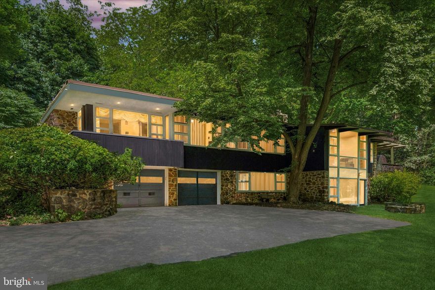 Great NEW PRICE! Another Mid-Century marvel located on one of Philadelphia's most sought after cul-de-sacs - Apalogen Road! Be sure to catch the virtual tour icon located on your screen.
This East Falls modern masterpiece is situated on over an acre of land, in a park-like setting, affording the benefits of both privacy and convenient access to all that the city has to offer. Lovingly maintained and updated by the current owner, this comfortable family home is spacious and features sun lit vistas from every room. A beautiful primary suite on the main level boasts a balcony for relaxing, complimented by a luxurious marble bathroom with two separate sinks and vanities, whirlpool soaking tub, free standing shower, and huge walk-in closet. Two more bedrooms on the same level are illuminated from bright picture windows, and served by a generously sized bath, with double sinks and granite counter tops. Architecturally stunning living room with natural stone walled fireplace, alongside dining room replete with solid walnut, both blending in an open, yet delineated, floor plan for gracious entertaining. Breeze in and out of the adjacent kitchen which boasts gas cooking with a Viking range and exhaust hood, and opens to a glass-walled family room which currently doubles as a home office. Speaking of cooking, both areas lead to a large deck with a custom made wood-fired pizza oven overlooking the front yard, which is well set back from the private road, and features a lovely raised koi pond. On the walk-out lower level, which is open to daylight, you will find a recreation/exercise room with a second stone walled fireplace, full bath, fourth bedroom, and a windowed utility room that is suitable for a home workshop. Adding to the mix is an over sized 2-car garage with interior access and laundry room. With a 12-minute drive into Center City, 4033 Apalogen Road is at the epicenter of recreational opportunities along the Schuylkill River, Wissahickon Creek, and Forbidden Drive. While located in a quiet and serene neighborhood, you will be at the convergence of major highways - I/76Expressway, Route 1/City Ave, both River Drives and Henry Avenue - all just a stone's throw away. East Falls train service, and the educational institutions of Penn Charter, Germantown Friends, and Thomas Jefferson University are all close by. This is a very special property that is not to be missed!