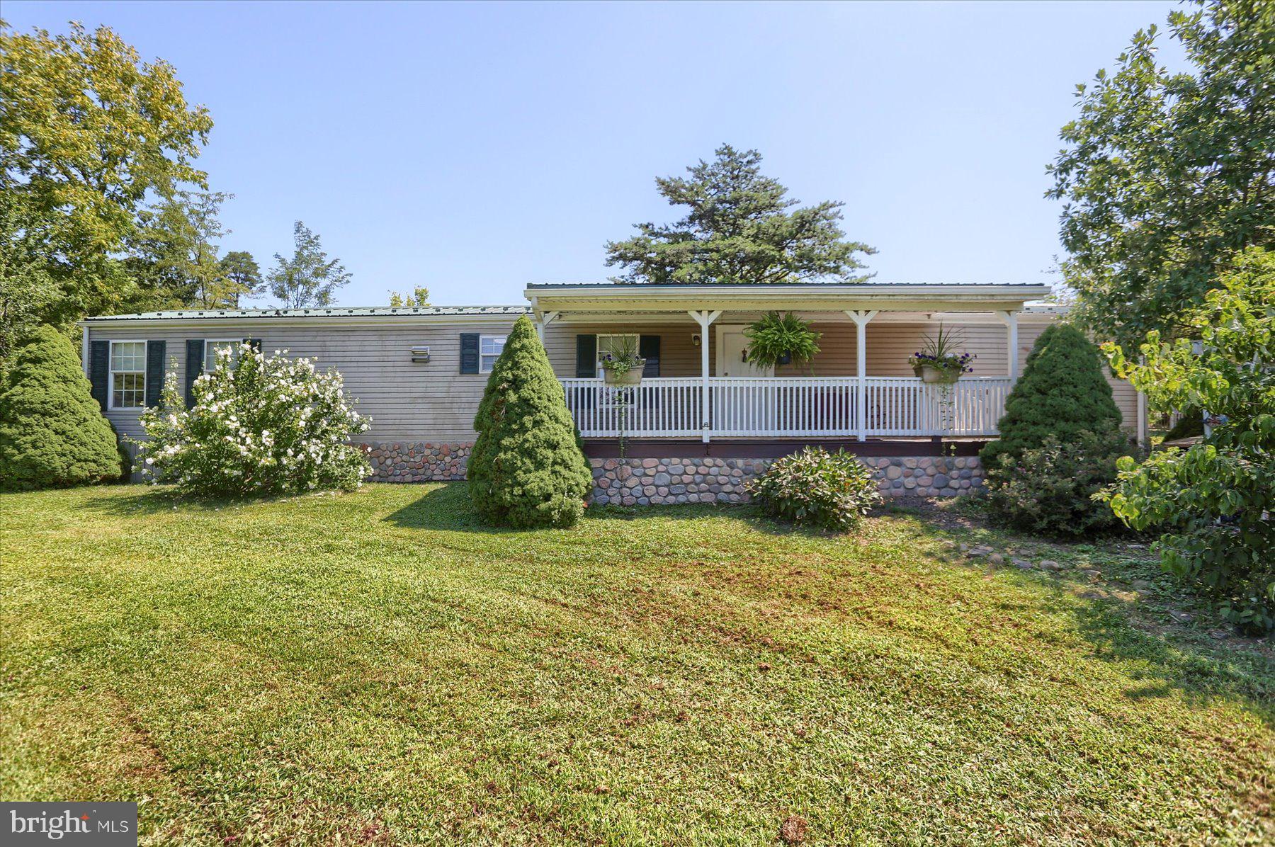 Welcome to your dream ranch home - where comfort, space, and functionality come together beautifully! This charming 4-bedroom, 2 full bathroom home offers over 1,600 square feet of well-designed living space all on one floor, nestled on a spacious 1.12-acre lot that provides plenty of room to spread out and enjoy. Step inside and fall in love with the open floor plan and a bright, airy family room - perfect for entertaining or relaxing after a long day. The kitchen is the heart of the home, featuring an abundance of cabinet storage and plenty of counter space to prep, cook, and gather with family and friends. Step out front to your oversized covered porch, ideal for morning coffee, evening drinks or just soaking in the peaceful surroundings. Out back, you'll find a detached 2-car garage with additional storage space and a separate workshop shed - perfect for hobbyists, DIYers, or extra storage. Whether you're hosting guests, starting a garden, or simply enjoying the quiet of country-style living, this property offers the perfect blend of space, charm, and potential.