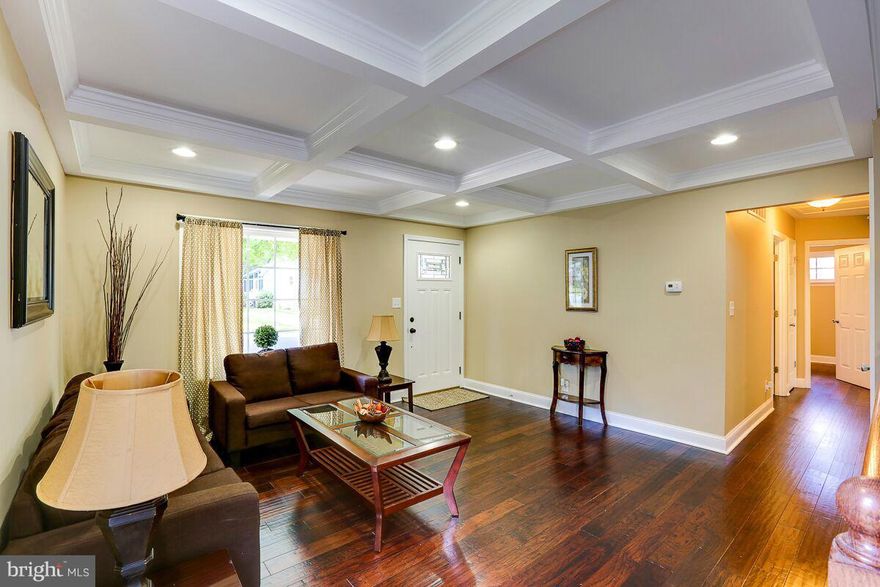 Stunning & stylish completely renovated brick front rancher w/ master bath. Beautiful Brazilian cherry hwd floors entire first floor. Coffered ceiling in living room w/ recessed lights. Crown molding on main level. Granite & SS kitchen w/ pantry. DR with skylights & French doors to backyard. Huge lower-level family room, 4th bedroom & recessed lights. 3 car driveway. Backs to County property.