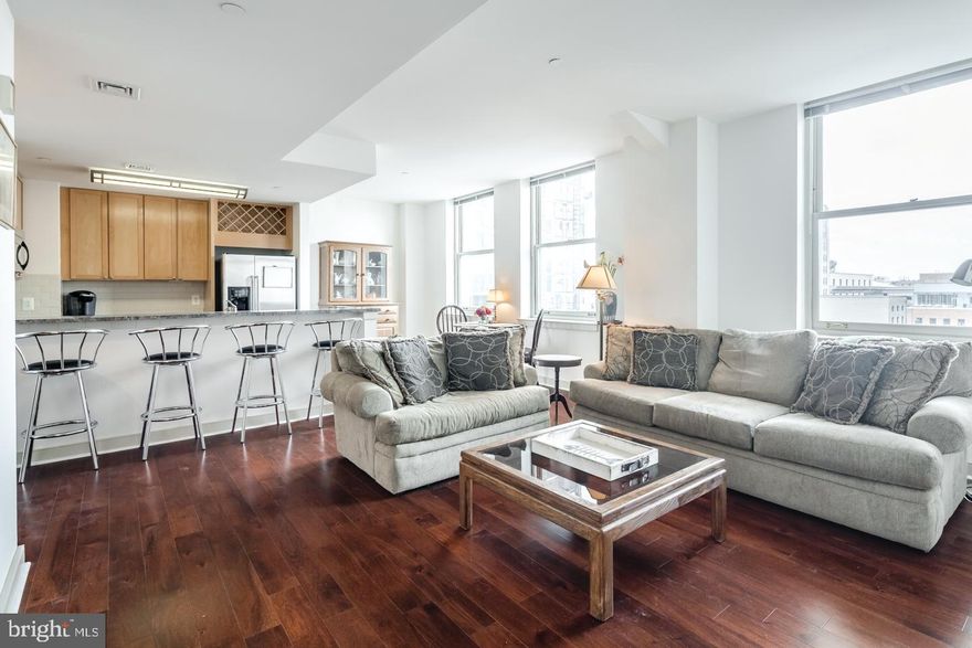Enjoy sweeping Center City skyline views from this highly coveted and oversized one-bedroom residence in the sky. The expansive living and dining areas feature soaring ceilings, gleaming hardwood floors, and oversized windows that fill the interior with an abundance of natural light. The gourmet kitchen is appointed with a breakfast bar, stainless steel appliances, and rich granite countertops. The bedroom is generously proportioned and offers ample closet space. The spa-like bathroom showcases ceramic tiles, chrome fixtures, and a ceramic sink with storage vanity. A 24-hour concierge, stunning rooftop deck, and on-site fitness center complete this desirable pet-friendly residence at the Packard Grande. Valet parking is available next door in a public garage. Perfectly situated in the Rittenhouse/Avenue of the Arts area, this home is steps from fine dining, world-class shopping, renowned cultural destinations, and vibrant nightlife. Conveniently close to UPenn/Drexel campuses, HUP/CHOP hospitals, and all major public transit lines.