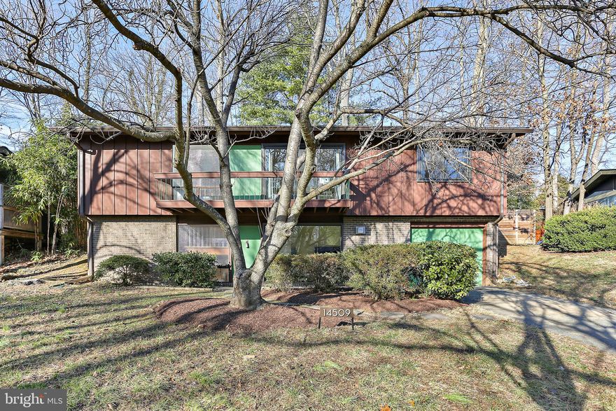 OFFER DEADLINE IS TUESDAY FEB 20TH AT 5:00 PM.  This Charming Deigert & Yerkes-designed MCM Bi-Level Home showcases an inviting open and airy floor plan and is highlighted by plenty of natural light. Step into the foyer and immediately notice the signature MCM open wooden staircase. To the right of the foyer is the Den with plenty of natural light. Continue to the large Laundry & Storage Room with Ceramic Tile flooring and access to the one car garage. Bedroom 4 is located on the lower level and offers plenty of natural light, a sitting area or study nook and access to the Full Bathroom with ceramic tile flooring, floating cabinet, and enormous standing shower with custom tile surround. Make your way up the impressive floating staircase to the Upper Level. The Kitchen is a culinary delight featuring a Café induction stove, maple cabinets with displays, and a large pantry. Continue to the Open Concept Dining Room & Living Room with a wall of new windows and access to the private custom fenced-in rear yard.  The gorgeous MCM Brick Fireplace has recently been retrofitted with Gas Logs and a new custom door. Hardwood floors flow seamlessly through to all three upper-level bedrooms. The Primary Bedroom with ensuite includes a floating vanity, ceramic tile flooring with radiant heat. The ceramic tile carries through from the standing shower to the walls. Generously sized Bedroom 2 and Bedroom 3 provide comfortable retreats while Bedroom 3 features a sitting area and a private balcony through sliding glass doors. The hall Full bath is spacious with a Tub-shower, pedestal sink and ceramic tile flooring. The home has plenty of storage with eight closets! Your private rear yard oasis is perfect for hosting family & friends, surrounded by a new custom fence with two access gates. Additional updates to this home include: New windows throughout, Oak Floor refinishing (2021) Glass tile backsplash, Quartz counters + SS sink and Kitchen faucets (2022), Professional Painting, Microwave (Whirlpool), Fridge (Whirlpool), AC handler, furnace, humidifier, smart thermostat, new LG Sidekick washer (2 washing machines), LG dryer (2023).   Located conveniently to Georgia Avenue and the ICC, the house is just 3 miles from the Rockville Metro Station and within walking distance to The Manor Woods Swim Club, local schools, Rock Creek Park, Dining and recreation centers! Don’t Miss the opportunity to see this gorgeous home! Schedule your visit today!