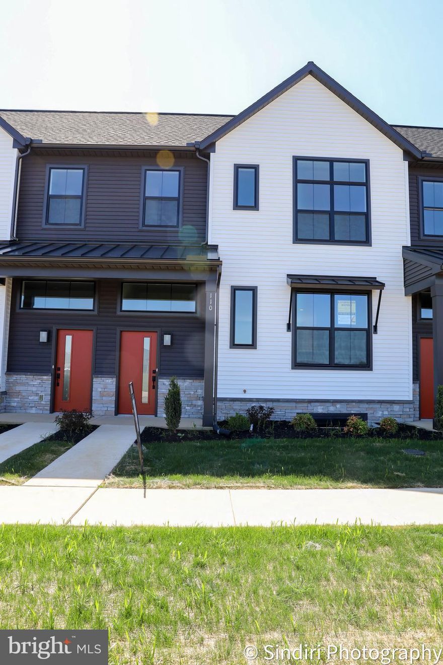 This 2-story townhome includes a 1-car, rear load garage, mudroom entry with built-in bench, and a patio for outdoor living. The first floor boasts 9’ ceilings. The kitchen, featuring stainless steel appliances, attractive cabinetry, and quartz countertops with tile backsplash, opens to the spacious dining area and adjacent to the sunny living room. All 3 bedrooms, 2 full bathrooms, and a convenient laundry room are located on the 2nd floor. The owner’s suite features an expansive closet and a private bathroom with double bowl vanity and 5’ shower.