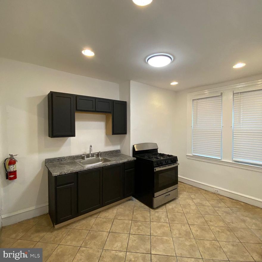 Spacious 3-Bedroom, 1-Bathroom Apartment for Lease – Move-In Ready!
This well-maintained second-floor apartment offers both comfort and character in a convenient location. The spacious eat-in kitchen features tile flooring, updated lighting, and a gas stove.  A refrigerator will be added. Adjacent to the kitchen is a versatile room that can be used as a living area or additional dining space.
Beautiful original hardwood floors run throughout the hallway and all three bedrooms, each of which includes a closet for added storage. The unit also features secure entry and a fire safety system for peace of mind. Tenant is responsible for gas and electric. Water is included in the rent. Conveniently located between the shops and eateries of Germantown Avenue, with immediate access to public transportation. Don’t miss out on this inviting and affordable space—schedule your viewing today!