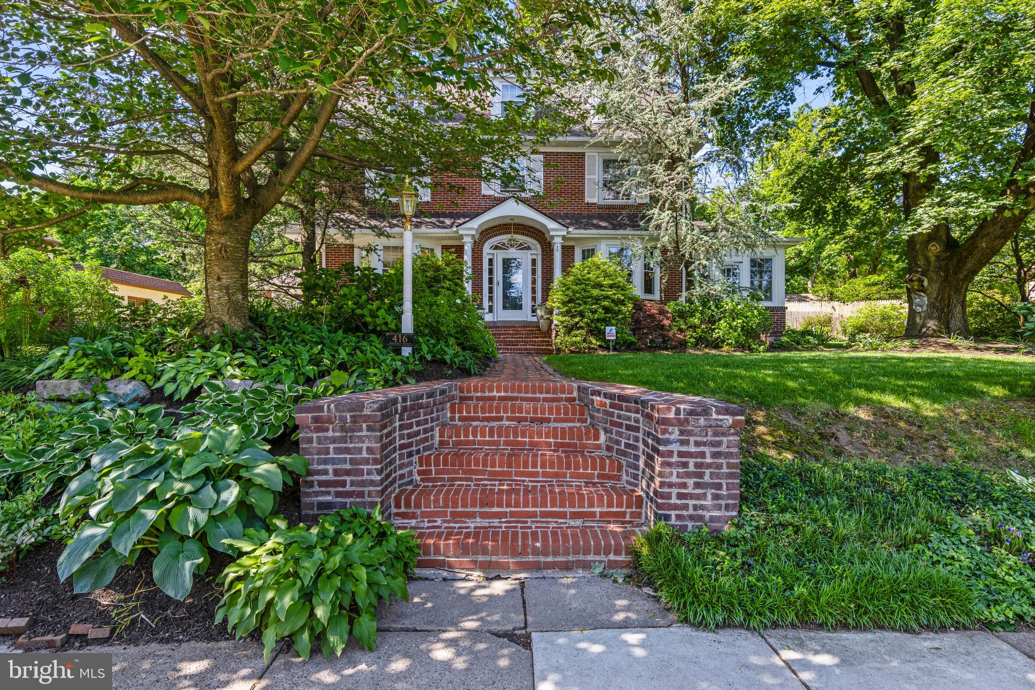Come discover this wonderful 3-story all-brick Colonial, constructed in 1940 on a tree-lined street with sidewalks everywhere for morning or evening walks.
The current owner is an avid gardener, and there is always something of interest in all four seasons. There is an amazing pink Cherry tree underplanted with astilbe & specimen hostas. There are heritage roses, clematis, peonies, allium, astilbes, lily of the valley, hydrangeas & even a Carolina allspice in the back yard. Perennials abound in all the various border gardens. Mature trees provide great shade, while the fencing & border plantings provide great privacy.
Elevated from the road, a series of steps takes you up to the covered porch. The original hardwood floors with decorative wood inlays around the borders are in beautiful condition. The center hall plan is familiar to everyone, with a spacious front to back living room on the west side with a full wall of built-in display shelves and storage cabinets. The heated 4 season sunroom overlooks the side yard with 2 sets of French doors and 2 exterior doors to the yard. The dining room has chair rails and a delightful curio cabinet on one wall.
The eat-in kitchen was just completely remodeled in 2024 and has made the most efficient use of space with an abundance of storage, quartz counters, marble backsplashes, a S/S apron-front sink w/ a garbage disposal, an electric stove, S/S dishwasher a French door refrigerator. There is a powder room tucked at the end of the center hall along with a coat closet and a door to the rear yard. Tucked into the corner between the 2-car garage and the kitchen is a delightful slate patio that is perfectly scaled for dining under the stars and to enjoy the vibrant plantings in the extra-deep rear yard.
On the 2nd floor, the owner’s suite occupies the entire space over the living room below with an en-suite bath that was remodeled in 2010 with a separate tub & shower. There are 2 more bedrooms on this floor with an adjoining full bath (also remodeled in 2010) with a large stall shower. The third floor has the 4th & 5th bedrooms along with two large storage closets and the 3rd full bath.
Downstairs, a portion of the basement has been finished and currently serves as a game room. The laundry room is right behind the game room, and there is ample storage in the unfinished portion of the basement where all the mechanicals are located.
The sewer line was replaced in 2006 and the roof was replaced in 2023. All of the windows have been replaced during the current owner’s tenure. There are two central A/C systems that were replaced in 2016 and 2022.
For those that know Wyncote, it is an amazing walking community, with sidewalks on most of the streets, five township owned parks in the community and the Glenside library & pool are just 3 blocks away. You can also walk to all the charming shops & restaurants along Easton Road in Glenside & Wawa. The Jenkintown/Wyncote SEPTA station provides the best service to Temple University, downtown Philadelphia, 30th Street Station, the universities & hospitals of Drexel & University of Pennsylvania & even the airport. Three train lines converge at this station, providing service every 10-15 minutes during peak hours. Just 5 minutes away, one will find many locally-owned businesses in downtown Jenkintown for dining, shopping and other service needs. Just 10 minutes away, one can find a Trader Joe’s and Whole Foods market in Jenkintown, and other grocery outlets are easily reached.
Olde Wyncote is a magical community where neighbors become friends and a diverse stock of architectural treasures abound on every street.