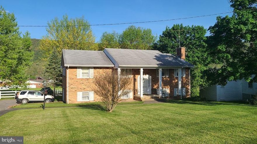 Spacious 4 Bed, 3 Bath Brick home conveniently located to all local amenities in Franklin.  This home boasts beautiful hardwood flooring throughout upper level. Unique tile flooring at entry and lower level.  Open Living Room/Dining Room, Updated kitchen with quality cabinetry, slide-out shelves.  Cabinet w/lift up shelf for stand mixer, stainless steel appliances, double wall oven. Use the pocket doors to close off kitchen from the LR/DR area when company comes.  Baseboard electric in each room w/individual thermostats, Central AC, Large laundry room with storage and sink,  Family room on lower level with wood burning fireplace.   Private backyard w/1000 sq ft., Detached garage finished in bead board w/bath, all insulated & heated. Plenty of room for the hobbyist or car enthusiast. Generator (not whole home) serviced w/in the last year.  Come see this beautiful home and the many extras it has to offer.  Some repair work needed.  SELLERS ARE MOTIVATED!