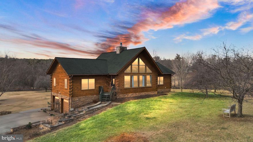Discover the perfect blend of rustic charm and modern luxury in this beautifully crafted custom-built log home, set on a serene 3-acre lot in Purcellville. Nestled on a peaceful dead-end road and surrounded by hundreds of acres in open-space preservation, this home offers unparalleled privacy and tranquility.

Constructed with 8" Kiln-Dried White Pine logs and 10x12 Hemlock beams, this residence showcases timeless craftsmanship with contemporary conveniences. Step inside to an open-concept living space featuring a dramatic two-story stone fireplace, soaring vaulted ceilings, and expansive windows that flood the home with natural light. Fiber available by Cladded Glass Broadband.

The spacious kitchen is a chef’s dream, boasting elegant white cabinetry, granite countertops, stainless steel appliances, and a large center island with seating. The main-level primary suite provides convenience and comfort, while additional rooms offer versatile space for a home office, gym, or guest accommodations.

Outside, enjoy breathtaking views from the elevated deck, perfect for entertaining or unwinding in peaceful surroundings. As a bonus, the seller is including a Kubota zero-turn mower, making it easy to maintain the expansive property.

With thermal insulation and a stunning blend of natural wood finishes, this home is a true retreat while still offering modern comforts. Don’t miss this rare opportunity to own a spectacular log home in the heart of Loudoun County, where peace and quiet meet modern living!