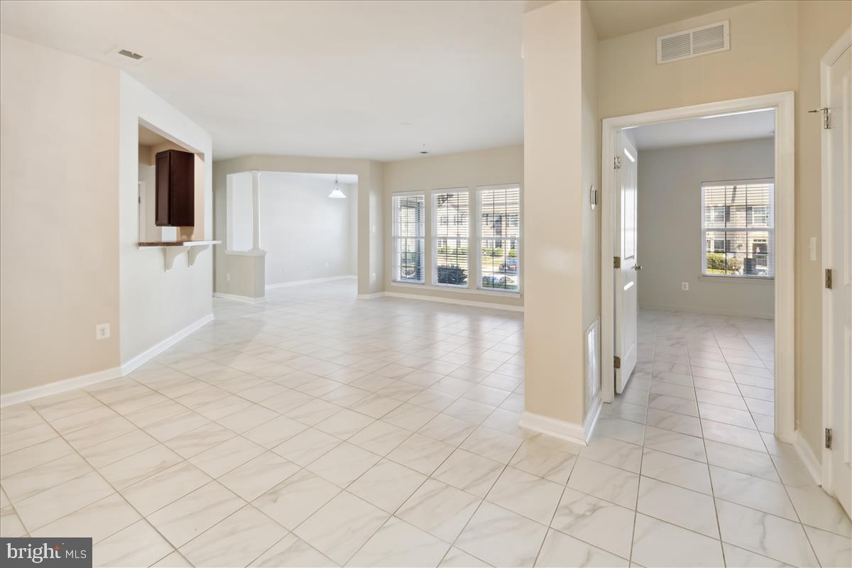 Wyndholme Woods is privately located at the top of a hill overlooking a private wooded area** This Fabulous two bedroom two bathroom condo i on first floor with lots of windows which makes it very bright**The condo has gorgeous upscale ceramic tile throughout** The open floor plan includes a den/office and separate dining area**The gourmet kitchen has 42" dark cabinets and neutral flooring**The owner's suite includes a full bath**There is extra storage located outside the door**This condo is in perfect condition and looks brand new** Colors are neutral throughout**There is ample parking** Show and sell this beautiful condo!