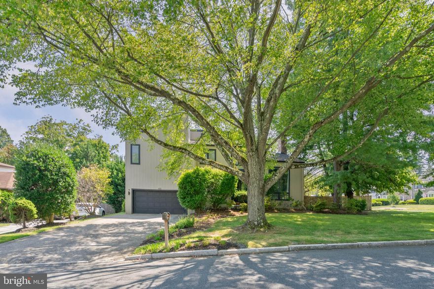Original midcentury modern character and distinctive details mirroring the pages of an architectural magazine are brought to life at 600 Argyle Cir. This 2,631 sqft home offers 4 bedrooms, 3.5 bathrooms, a 2-car garage, a semi-finished basement, a fantastic backyard, and placement in the award-winning Lower Merion School District. First impressions are impressive when approaching the manicured corner lot, where shady trees, lush shrubbery, and an angular facade create idyllic curb appeal. Inside, you're welcome by a foyer with a coat closet and a powder room. To the left is the first bright and spacious bedroom that's ideal for an office. To the right, soaring vaulted ceilings and gleaming hardwood floor frame the palatial living room and dining room. A towering stone fireplace helps define the two areas, while massive windows at the front, rear, and overhead provide tons of natural light. Friends and family can spread out comfortably during holidays and celebrations, plus patio doors off the dining room allow for easy indoor/outdoor entertaining. More living space is found back in the den, which is sure to be the weekday hub of the home with its partially open layout that connects to the breakfast nook and kitchen. Picturesque windows overlook the expansive backyard where you can spend your summer days barbecuing, gardening, playing in the grass, and dining under the stars. Completing the main level is a laundry room and access to the garage. Up on the second level, the primary suite has a large bedroom, a walk-in closet, a make-up vanity, and a terrace with treetop views, perfect for relaxing with a morning cup of coffee. The attached full bathroom has a double vanity, a tub, and a second glass-enclosed shower. Off the hall, there's another full bathroom, an additional walk-in closet, and three spacious bedrooms, including one with cool built-ins and a loft area. Finishing the home is a semi-finished basement with space for guests, a gym, and storage. 600 Argyle Cir's sought-after location is less than 5 minutes from shopping in Wynnewood and Suburban Square with stores like Whole Foods, Trader Joe's, and Target. Sprawling South Ardmore Park is steps away, Lankenau Medical Center is close, plus there's easy access to Lancaster Ave and City Ave. Schedule your showing today!