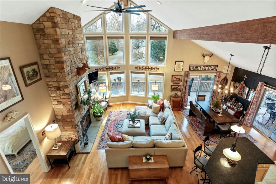 Owner is listing agent, feel free to reach out with any questions or to see the home.

Luxury Golf Course Retreat in The Woods Resort with Class A membership available.

Tucked within the tranquil beauty of The Woods Resort, this exceptional contemporary residence offers a refined blend of luxury, comfort, and resort-style living.  Surrounded by mature trees and overlooking the scenic golf course, this meticulously maintained home presents a rare opportunity to experience sophisticated living in a peaceful natural setting.

Built in 2004 and spanning over 3,176 square feet, the home features five spacious bedrooms and three full bathrooms, thoughtfully designed to accommodate both elegant entertaining and relaxed everyday living.

From the moment you enter, the home welcomes you with a light-filled open floor plan, enhanced by rich hardwood flooring, soaring ceilings, exposed wood beams, and expansive windows fitted with UV film that frame the surrounding landscape. At the heart of the home, the dramatic family room showcases a striking stone fireplace, creating a warm and inviting focal point for gatherings.

The adjoining gourmet kitchen blends style and function, featuring a generous center island, modern appliances—including refrigerator, stove, microwave, and dishwasher—and seamless connectivity to the living spaces. Whether preparing a quiet dinner or hosting friends, the design allows you to cook while enjoying the ambiance of the fireplace and the company of guests.

Designed as a private sanctuary, the primary suite offers direct access to the deck with sweeping golf course views, a spacious walk-in closet, and a well-appointed ensuite bath with a stall shower. The home’s flexible layout continues upstairs where a spacious loft with a convenient half bath can serve as an additional bedroom, office, or creative studio.

The fully finished walk-out lower level expands the home’s living possibilities, bathed in natural light from large windows and offering private exterior access. Perfect for a home theater, wellness studio, recreation room, or guest retreat, this level adapts beautifully to any lifestyle.

Outdoor living is equally impressive. Multiple spaces invite you to unwind and entertain, including an elevated deck and screened porch overlooking the golf course, a private hot tub for starlit evenings, and a carefully curated fire pit gathering area. The professionally landscaped grounds, framed by trees and scenic views, provide a peaceful retreat from the pace of everyday life.

Additional features include a detached garage with extra storage, a spacious bonus room above the garage, and an asphalt driveway for convenient access. The home has been thoughtfully updated with a new roof installed in 2021 featuring a 50-year architectural shingle by Modern Renovations, as well as new carpet in the main-level bedrooms.

Residents of The Woods enjoy access to an exceptional lifestyle community. All homeowners may visit the Spa and Clubhouse restaurant (currently being rebuilt), while a Class A Membership is available for those wishing to take full advantage of resort amenities including:

Championship golf

Indoor and outdoor swimming pools

Fitness center and wellness facilities

Pickleball and tennis courts

Spa services

The neighborhood also features a charming community park that hosts seasonal festivals, scenic nearby hiking trails, and a variety of social clubs for reading, gardening, crafts, dining, and more.

This remarkable property is more than a home—it is a private retreat offering luxury, tranquility, and a vibrant community lifestyle in one of the region’s most sought-after resort settings.  Many clubs and activities are offered in the community.

Please use provided shoe covers during showings. ✨🏡