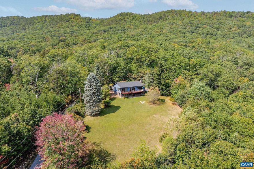 Set high in Virginia?s Blue Ridge, this 76-acre property combines a fully modernized mountain cabin with extraordinary views and direct access to George Washington National Forest. The 1,882 sq ft home, offering 3 bedrooms and 3 baths, underwent a complete renovation in 2022 with a fully updated interior and exterior. An open layout filled with natural light highlights the surrounding landscape, while a walkout basement provides easy potential for additional living space. The wooded acreage is ideal for hunting, hiking, and outdoor recreation, with high elevation vantage points across the mountains. A 600 sq ft barn and two additional outbuildings add flexibility for storage or hobbies. With its updated home, expansive acreage, and private setting, this property is equally suited as a primary residence, retreat, or recreational escape.