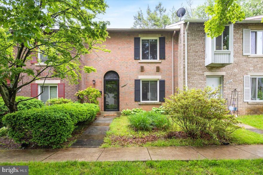 Tucked back in Maryland Place, this quaint townhome is fresh and ready for new owners!  Off the main road through, the quiet brick front property welcomes you with mature trees on the common area.  Once inside, a closet offers storage and you can test new recipes in the kitchen with granite countertops and updated white cabinets. The kitchen offers space to eat in, or the living space is large enough to be creative with dining seating. The living space opens to the backyard which allows lots of light inside through the glass. Enjoy the sounds of nature from the privacy of your patio. A shed stands for any storage needs. 
The laundry is also housed on the main level with extra storage under the stairs. Upstairs, two generously sized bedrooms await, the larger one on the backside of the property for extra privacy. A full bath upstairs has extra counter space with storage and creative wall storage as well.  Montgomery Village provides many amenities, and this property is just under 6 miles to Shady Grove Metro. Shopping, bus stops, restaurants are all easily walkable. Miles of walking trails and Whetstone Lake provide plenty of enjoyment for those who love the outdoors. 
Two assigned parking spaces complete this lovely property. You’ll never have to worry about someone taking your space again!