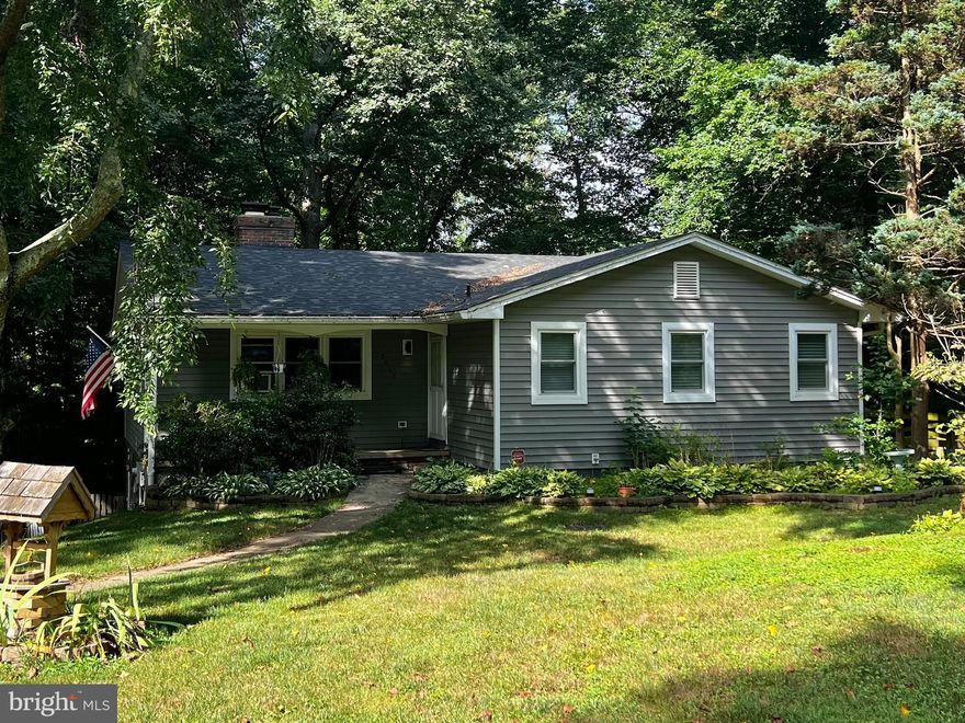 Welcome to your dream home in the sought-after Fairway community of Bel Air! This charming 3-bedroom, 2.5-bathroom rancher sits on a lush 0.66-acre wooded lot with a tranquil stream, offering the perfect blend of privacy and natural beauty. Please note, this property is being sold in "As Is" condition, presenting an incredible opportunity for you to add your personal touch and create the home of your dreams. Third-party approval by the bank is required. Step inside to discover an inviting foyer with elegant tile flooring, leading you to a spacious living room featuring a stunning double-sided wood-burning fireplace. The rich hardwood floors throughout the main level add warmth and style to every room. The open-concept dining area flows seamlessly into a well-appointed kitchen with laminate flooring, equipped with matching LG appliances, including a refrigerator, chef top oven, microwave, and dishwasher, all of which are only three years old. The primary bedroom is a peaceful retreat with its own attached bath featuring laminate flooring, while two additional bedrooms and a full bath, also with laminate flooring, provide ample space for family or guests. Head downstairs to the lower level, where you'll find a versatile partially finished basement complete with a walkout, a convenient half bath, and an unfinished area ready for your customization. The expansive, fully fenced rear yard is ideal for outdoor activities, gardening, or simply enjoying the serene surroundings. This home also features an asphalt driveway with additional on-street parking, a water softener system, and a French drainage system throughout the front yard. A brand new garage was built two years ago. The well and entire pump system were drilled and installed in 2015, and an onsite sewage disposal system (BAT3) was installed in 2016. For energy efficiency and comfort, the entire house is equipped with top-of-the-line double-paned, double-hung silencing windows with triple seal. In 2020, new Tyvek house wrap and modern insulated siding were installed, along with new roof shingles. The home includes a full HVAC system providing centralized air conditioning and heating, installed three years ago, and a washer and dryer, both only three years old. Totaling approximately $80,000 in recent upgrades, these improvements ensure that this home is move-in ready and equipped for modern living. Don’t miss out on this unique opportunity to own a slice of paradise and make it your own. Schedule your showing today and envision the endless possibilities this delightful rancher has to offer!