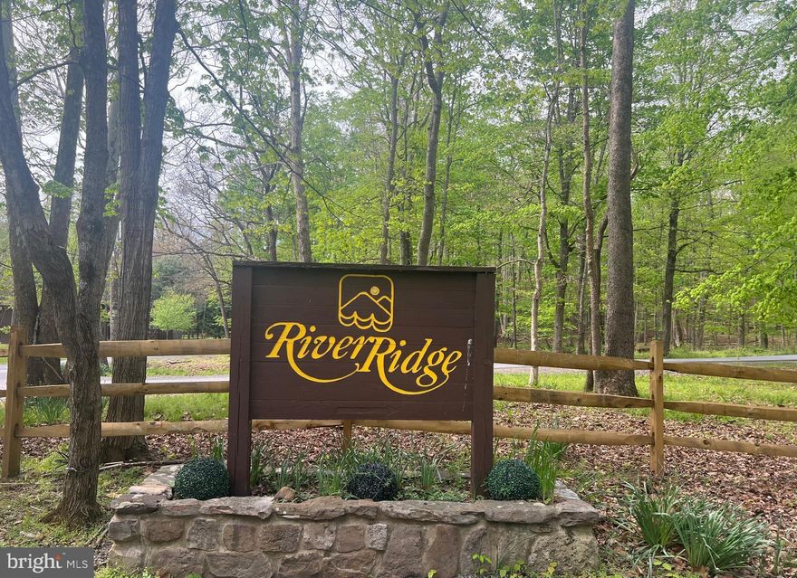 Nestled off of Butterfly Ln, this beautiful 6.12-acre lot offers a rare "blank slate" opportunity within the prestigious River Ridge gated community. Residents enjoy premier access to the Cacapon River, complete with excellent amenities like a communal bathhouse, kayak storage, picnic areas, and cozy firepits. Whether you envision building a permanent custom estate, a private weekend escape, or a high-potential short-term rental, this expansive acreage provides the perfect foundation. The location strikes an ideal balance between seclusion and convenience, situated approximately 15 miles from the historic charm of Berkeley Springs. This proximity allows for easy afternoons exploring local spas, dining, and the renowned Berkeley Springs State Park. Grab your house plans and your outdoor gear to embrace a slower, river-oriented lifestyle in one of the area’s most desirable subdivisions.