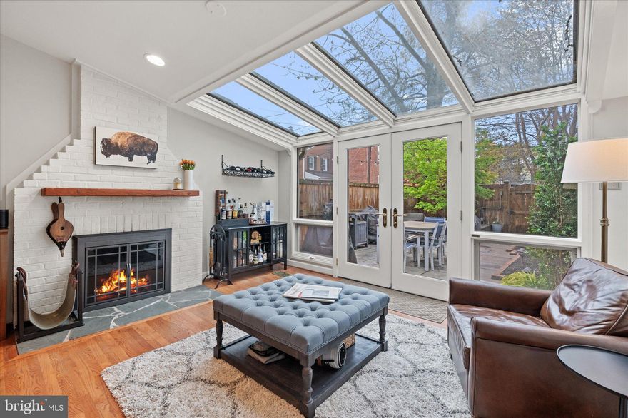 ***OFFER DEADLINE 3PM MONDAY APRIL 28*** Beautiful, spacious and sundrenched end-townhouse in the heart of Old Town Alexandria! Upon entering 908 Queen, you're greeted by a light-filled space and gleaming hardwood floors. On the first level, you'll find the living /dining room, large powder room, and a wide, updated kitchen that opens into one of the most beautiful and light-filled rooms you'll find in Old Town, featuring French doors, floor-to-ceiling windows and a ceiling full of skylights. 

From the sunroom, step through the French doors (featuring new Phantom retractable screens) onto the spacious patio featuring updated landscaping and perfect space for al fresco meals,  an intimate evening with friends around a firepit, and more. Private parking (accessible via alley), a storage shed and a firewood rack for your wood-burning fireplace are all just on the other side of the fence. 

Head upstairs to find the large primary bedroom featuring more natural light via the bay window, double closets, and an attached full bathroom. Down the hall is another full bathroom and the second bedroom. The 3rd level offers space for a bedroom, private office, exercise area, or more! Plus tons of storage and a private deck with city views, overlooking the patio. 

For those who are looking for the walkability and accessibility of city living, this is it! Just 2 blocks to King Street, less than a mile to 2 Metro stations, and 1/2 a mile to the waterfront, 908 Queen truly offers the space, convenience and everything to love about the Old Town Alexandria lifestyle.