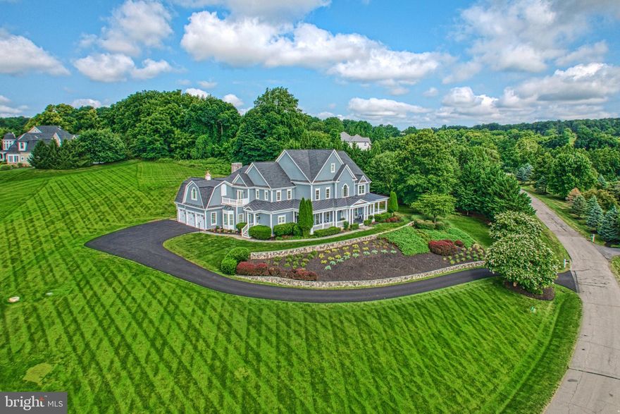 In distinguished Beacon Hill, where scenic grounds feature homes of traditional and custom design, this sunlit farmhouse beauty sits hill-top, as enviable cul-de-sac-privacy leads to your sweeping stone-lined welcome. Originally constructed and recently polished with high-end finishes, your memories to come will enjoy a backdrop of wide-plank hardwoods, encased transitions, field-stone fireplaces, and the charming architectural detailing of alcoves, thoughtful built-ins, and handcrafted ceilings. Unwind the day’s cares and entertain within grand and cozy living vistas near your kitchen of provincial personality. Here, homework can be completed at the nearby business nook, while dinner and sweets for celebrations are prepped with the help of beveled stone countertops, endless glazed cabinetry, butlers pantry, and centerpiece range. Practice yoga or train upstairs in the window-lined gym, let the cheerful mudroom prep outings, unwind with friends on the wrap-around porch, and host luncheons on the
patio where three acre grounds will have you planning the pool of your dreams. Five bedrooms, plus over seven baths, care for winding down the day. While the rare main-level suite is perfect for multi-generational long-term guests, your impressive primary escape both invites you to stay and readies evenings-out with its fireplace-warmed sitting room, dual closets, and spa-like bath. While touring, ask about upgrades including new roof, and visit the lower level where a gorgeous place for recreation awaits with stunning modern wet bar, theater, full bath, and flex/storage spaces. From home, enjoy Beacon Hill’s shaded walking trails, or take a favorite vehicle from your three car garage toward historic downtown Leesburg, OneLoudoun, IAD, local eateries, shops, and all Horse and Wine Country has to offer.