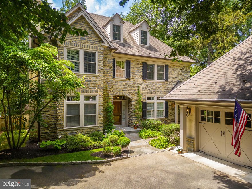 Welcome to 8208 Ardmore Avenue, a stunning 4 bedroom, 4.5 bath stone and stucco home with a modern and functional layout on a lovely residential street in the heart of sought-after Wyndmoor. Upon entering the grand 2 story center hall, you are met by a gracious sitting room on your right, and a spacious formal dining room with gas fireplace and marble-topped built-ins with shelving. The sunlit kitchen features honed black granite countertops, center island, Wolf six-burner stove with pot filler, Sub-Zero refrigerator, double drawer dishwashers, wine cooler, glass front cabinets, and butler's pantry area with wet bar and large walk-in pantry space. Acting as the hub of the home, the kitchen is open to the adjoining breakfast area and looks over the step-down family room with gas fireplace and glass doors out to the lovely rear slate patio. Rounding out the first floor is a gorgeous wood-paneled home office overlooking the backyard, a powder room, and a large coat closet. Whether you use the main or secondary staircase, the second floor will surely impress with two nicely-sized bedrooms with a shared hall bath, a third bedroom with an ensuite bathroom, and a convenient second floor laundry room. The primary suite is a serene place for relaxation, with a sitting room, dual walk-in closets, gas fireplace, and lovely bathroom featuring a clawfoot tub, large walk-in shower, double vanities and separate water closet. The third-floor bonus room with walk-in closet could easily act as an entertainment area, media room, guest bedroom, secondary home office, play room, or storage space. The fully finished basement offers a recreation/game area with ample space for entertaining, with a walk-in wine cellar, exercise room with rubber flooring, and a full bath. Outside you will find a gated front entrance, spacious two-car garage, a beautiful two-tiered bluestone patio, an adorable koi pond with a fountain, and lush, mature landscaping surrounding the property. This home is in a fantastic location in the Springfield Township School District, just a short stroll away from the fantastic shops and restaurants on Willow Grove Ave and Chestnut Hill, just minutes from the trails of Fairmount Park and offers easy access to major roads and local trains, making commutes or recreational trips to Center City, Philadelphia (around 30 min) and NYC (around 105 min) a breeze.