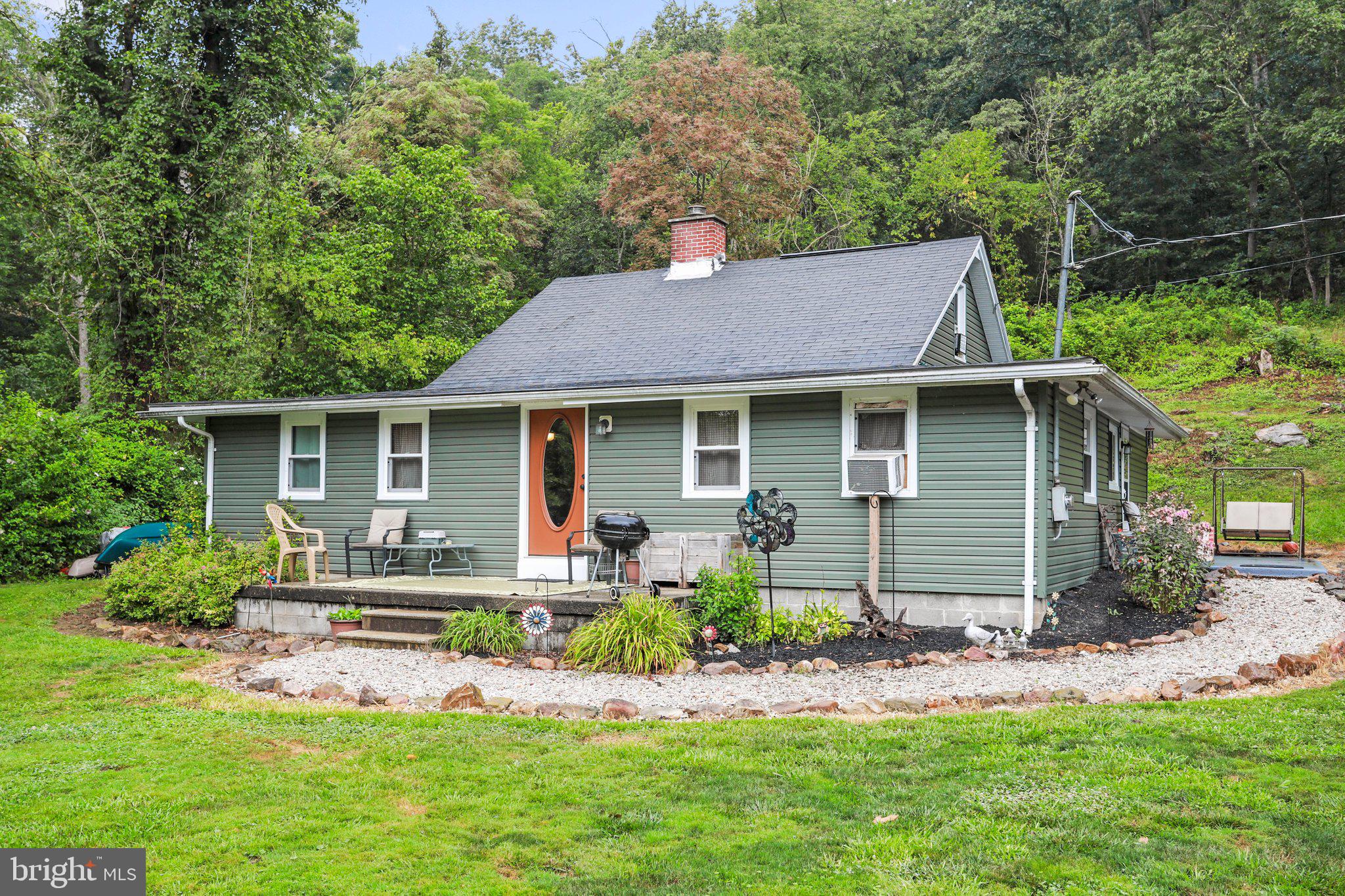 Welcome to your dream retreat on the banks of the picturesque Potomac River in West Virginia. This charming residential/vacation home offers the perfect haven for water enthusiasts and nature lovers alike. With 1624 square feet of cozy living space, this two-bedroom, one-bathroom home also boasts a captivating bonus loft bedroom and ample attic storage. Inside, the heart of the home is a stunning and grand stone fireplace that not only adds a touch of rustic elegance but also ensures warmth and comfort during any storm. The open and inviting layout seamlessly connects the living areas, creating a sense of togetherness. This home is situated on an easily maintained 0.47-acre property. With a large yard and ample space along the river for relaxation and outdoor activities, gatherings and games. If you're a fan of water activities, you'll be in paradise. The Potomac River beckons you to enjoy swimming, fishing, and floating to your heart's content. For those who yearn to explore the wilder side, this property holds a unique advantage. Just steps away from the White Horse Wildlife Management Area, a sprawling expanse of around 1700 acres. This natural playground is a haven for hiking, hunting, and uncovering the beauty that West Virginia has to offer! Located only 15 minutes away from both Romney and Fort Ashby. These nearby towns provide access to essential amenities and services, ensuring that you have the best of both worlds – rural tranquility and modern convenience. Whether you seek a peaceful weekend getaway or a permanent retreat from the bustle of city life, this West Virginia gem offers a unique blend of water-focused relaxation and outdoor adventure. Experience the magic of riverside living and create a lifetime of cherished moments in this idyllic home by the Potomac River.