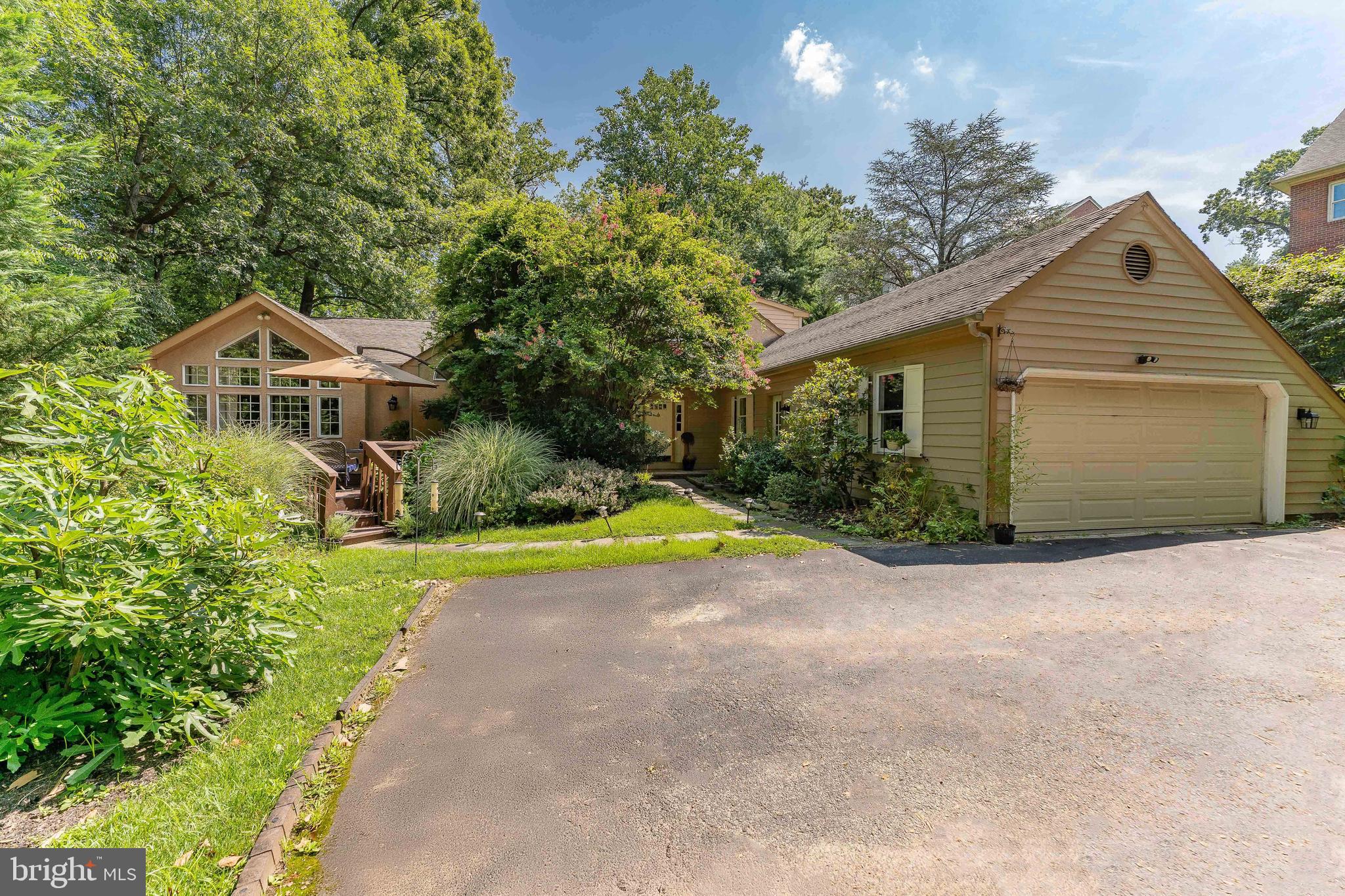 Welcome to 406 Brighton Circle, a spacious 5-bedroom, 4.5-bathroom single-family home located in the sought-after Tanglewood neighborhood of Devon. This beautifully maintained home offers generous living space, both indoors and out, along with a prime location close to nature, shopping, and more. As you arrive, you're greeted by a welcoming front deck and a 2-car garage with built-in storage for added convenience. Step inside to a grand two-story foyer featuring gleaming hardwood floors and an elegant chandelier, setting the tone for the rest of the home. The main level includes multiple gathering spaces, beginning with the formal living room—complete with hardwood floors, crown molding, and direct access to the back deck. The adjacent dining room features hardwood flooring, crown molding, chair rail detailing, a ceiling light, a bright triple window, and another door to the deck—perfect for entertaining. The kitchen is both functional and stylish, offering tile floors, granite countertops, stainless steel appliances, and a pantry for extra storage. The kitchen opens to a cozy sitting room with vaulted ceilings, skylights, a ceiling fan, carpet flooring, and a stone-surround gas fireplace—an ideal spot to relax. Nearby, the large family room features carpet flooring, soaring ceilings, and sliding glass doors that lead out to the expansive front deck. A charming breakfast room with tile floors, vaulted ceiling, ceiling light, and built-in cabinetry adds additional space for casual dining. The first-floor primary suite is a true retreat with carpet floors, vaulted ceilings with skylights, a ceiling fan, a walk-in closet, and private access to the back deck. The luxurious en-suite bathroom includes tile flooring, a vaulted ceiling with skylight, dual vanities, a walk-in shower, and a jetted tub. Just off the foyer, you'll find a powder room with hardwood flooring and a dedicated laundry room with built-in cabinetry, and access to the garage. Upstairs, you'll find the second bedroom with vaulted ceilings, carpet flooring, and its own en-suite bathroom with tile floors and a step-in shower. The third and fourth bedrooms both feature carpet flooring, ceiling fans with lights, and generous closet space. These rooms share a Jack-and-Jill bathroom with tile floors and a tub/shower combination. The finished walk-out basement offers incredible additional living space. The lower level includes a spacious game room, a second family room with a bar area and built-in cabinetry, and a fifth bedroom with direct access to the patio—perfect for guests or a home office. A fourth full bathroom with tile floors and a step-in shower completes this level. Outside, enjoy multiple deck and patio spaces ideal for entertaining or relaxing. Conveniently located just minutes from local shopping, grocery stores, restaurants, and more, this home also offers walkable access to Jenkins Arboretum & Gardens and Teegarden Park. Don’t miss your chance to make this exceptional home yours!