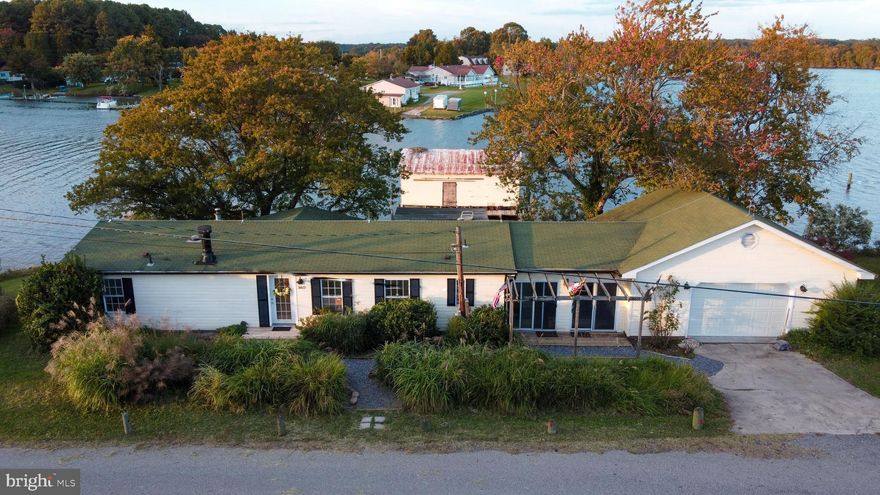AMAZING VIEWS come with this waterfront property on deep protected water. Approximately 258 feet of water frontage with easy access to open water. Great location. It has 3 decent sized bedrooms and 2 full bathrooms. There are many updates throughout including new flooring, fresh paint, ceramic countertops. Open concept floorplan with lots of windows to take full advantage of the views. There is a deck across the rear of the house with a hot tub. Shoreline has been rip-rapped. Peace and serenity here in your own little private paradise. Enjoy watching waterfowl and you can fish and crab right in your back yard! Great for a year-round residence or for a fun  and close by escape from the city - or weekend place. Just a little over an hour from DC! It even has a nice sized garage with plenty of storage.  Also, some special fun  features  -  the claw-foot bathtub and pedestal sink in the hall bath were allegedly were on the set of the movie The Day the Earth Stood Still. Also the historical little Delco  House on the property -The Delco House is an artifact of Southern Marylands -- and rural Americas -- history.  Prior to FDR's Rural Electrification Act of 1936, growing electric utility companies were not required to make electricity available to remote areas of the United States, but were allowed to concentrate on more profitable urban enterprises.  To try to stay up to speed with the growth of domestic technology in the country, the farmers and watermen of Southern Maryland -- like farmers across the country -- purchased small direct current DC generators from companies including Delco -Detroit Electric  which could charge and maintain a rack of batteries that provided limited 32 volt DC electric light and household appliances for farmhouses.  In Southern Maryland, these miniature Delco-Light powerplants were often housed in eight foot-square, green triangular-roofed clapboard outbuildings which came to be known, generically, as Delco Houses. Only a few of these buildings remain in St. Marys County.  This Delco House represents a slice of history from the first half of the twentieth century, which gave our farmers and watermens families a taste of the fast growing technology that we take for granted today. Do not miss out on this gem!!