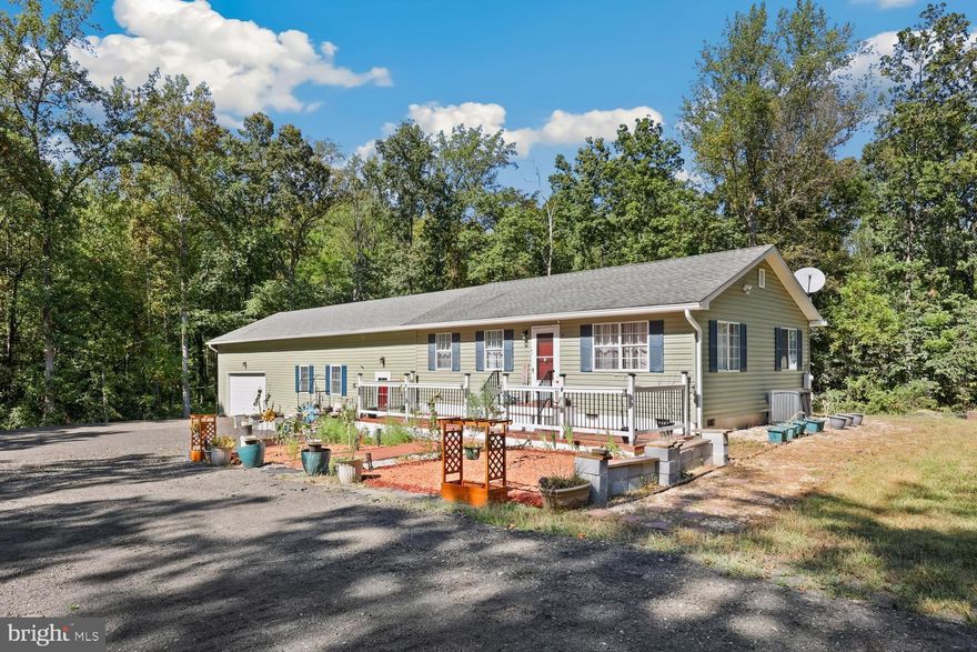 Cozy ranch-style home offering nearly 1,700 sq. ft. of living space with a spacious addition (installed November 2024) that provides an abundance of extra room. This property is move-in ready and includes a newly built 24x24 car garage with remote entry, plus a driveway that can accommodate up to 10 additional vehicles. The 2-acre wooded lot offers plenty of privacy and has been enhanced with an abundance of new fruit-bearing and flowering trees planted throughout the property.

Multiple outbuildings add versatility, including one shed for tools and equipment and another that can easily be transformed into a hobby room , workshop or yoga room. Inside, five elegant chandeliers with retractable ceiling fans elevate both comfort and style.

The home has been beautifully updated between 2022–2025 with luxury vinyl plank flooring throughout, fresh paint, updated lighting, a renovated bathroom, a new deck, and a welcoming front porch. The kitchen shines with granite countertops and stainless steel appliances, including a refrigerator, dishwasher, electric stove, microwave, and dryer (all 2022) and a brand-new washing machine (2025). Enjoy living with 3 spacious bedrooms and 2 full baths. Step outside to a private deck overlooking a massive backyard—perfect for relaxation, entertaining, or simply enjoying the peace and quiet.

Nestled in a serene, friendly neighborhood just 5 minutes from C. M. Crockett Park (the largest lakeside park in Fauquier County), 15 minutes from Old Town Warrenton, and with easy access to Rt. 28 for commuters, this home is truly memorable.