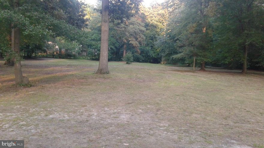 This is a land/lot listing only.  The property is located behind and to the right of the front view of the house.  Approximately an acre is available to be subdivided and sold.  This property was in the process of subdivision a number of years ago and stopped mid-way into the work.  Property pin bars were installed... but the finality of the subdivision was never completed.  There is public water and sewer in the neighborhood, the lot is level and has an easy option for accessibility from the side road.