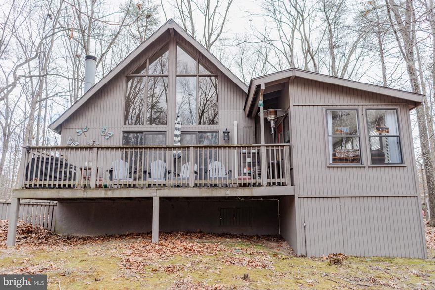 **Back on the market at no fault of seller!** Discover unparalleled tranquility in this enchanting 2-bedroom, 2-bathroom residence, beautifully situated on a sprawling one-acre lot within a serene neighborhood. Upon entering, be embraced by an abundance of natural light that illuminates the inviting interiors, featuring an open floor plan that seamlessly integrates cozy living spaces. The centerpiece of the home is the indoor fireplace, providing warmth and ambiance during chilly evenings. Adjacent to the residence, a thoughtfully designed outdoor fire pit awaits, offering the perfect setting for gatherings under the stars. A sunroom serves as a tranquil retreat, while a wooden deck showcases mesmerizing forest views, creating an idyllic backdrop for alfresco dining or morning reflections. The property further boasts a small fenced-in yard, ideal for small pets, and a convenient shed for additional storage needs. With its harmonious blend of comfort, elegance, and natural beauty, this home promises a lifestyle of serenity and sophistication. Experience the magic of this unique property and imagine the memories waiting to be made in your private oasis.