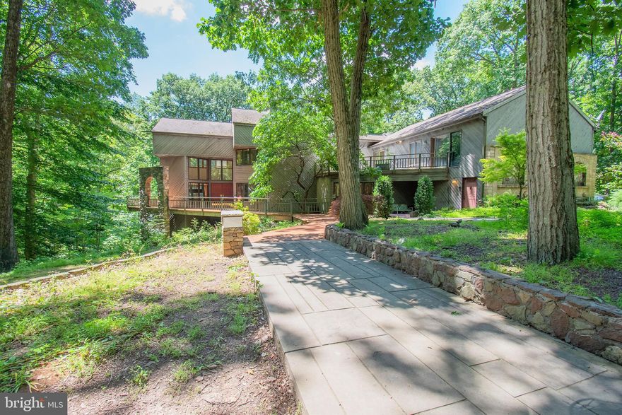 Welcome to 66 Penn Oak Trail, your secluded retreat nestled in the woods in an exclusive setting on 6+ acres! Complete privacy awaits and unending spectacular views from all angles! Step back and appreciate the details of the impressive entry complete with stone arches, bridged pond along with hardscape seating and entertaining areas. As you step inside, you will be awe of the views! Take a moment to admire the exquisite custom designed railing that flows to the level above and down to the family room. The entry provides an overlook to the family room/ game room showcasing tons of natural light and offering captivating backdrops at any season. To your right, capture the expansive view of the main living areas. The state of the art kitchen is a chef’s dream! Properly outfitted with superb details, elegant cabinetry, a sea of granite, two cooktops, subzero refrigerator with a wine fridge. The kitchen adjoins the dining room, notice the double sided wood fireplace, with plenty of space for all of your holiday gatherings. This area flows into the living room with the cozy fireplace and dramatic views. On this level you will also find a bedroom, currently used as an office with a private bath which opens to a  garden. This hallway also provides a second staircase to the second floor, entry to the four car garage, utility room and large pantry. On the lower level you will find the family room with floor to ceiling windows, a wood fireplace, wet bar and a half bath. A great gathering space for any celebration! Step down from this area to a stone wine cellar, host your own tasting parties in this cozy space! Feel the need for extra office space or gym, an additional room on this level offers a multitude of options. Time to roll out the red carpet and head down to the state of the art Theatre room which has its own entrance. Entertain your family and friends in this awesome setting offering surround sound, special lighting and a big screen. Don’t forget the popcorn and a list of your favorite films! Back to entrance and up the main stairs you will find a private, grand double door entrance to the Master Suite. This suite offers amazing views and an expansive private deck. The master bathroom is large, complete with glass shower enclosure which adjoins another bath for his and her areas and separate sunken tub. This floor offers two additional bedrooms, bathroom, tons of closet space and a separate laundry area. Let’s not forget the in law suite! It is a home within this home. This suite includes its own private entrance and/or can be accessed through a separate locked door to the home. The kitchen is well equipped with all appliances, beautiful cabinets and granite counter tops. The living area is large, offers plenty of sunlight and a slider to the deck! The bathroom has dual sinks, heated floors, Jacuzzi tub and separate glass shower enclosure, there is also a separate washer and dryer. This suite offers a large bedroom with a huge closet and those great views. Let’s not forget the four car garage which offers plenty of room for your cars and toys with room for workspace. The garage offers true car enthusiasts options with extra space to work including an under the floor pit for repairs. This home has so many additional features, surround sound throughout the home, central vacuum system, several heating and cooling zones and multiple decks for breathtaking views. All of this home has to offer is best seen and appreciated in person, make your appointment today.