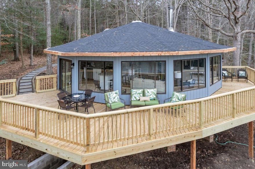 Unique 1977 Rondesics R-15 Model with Chalet Roof offers mid-century round house architecture, with total privacy on the very protected Brooks Cove near Solomons. This 3BR/2BA waterfront home is the perfect retreat and the offering includes an extra waterfront lot, totaling 400 ft of shoreline with a deep water pier-great for boaters, crabbing and fishing.  Recent renovation highlights include a new roof, new flooring, fresh paint, brand new kitchen and bathrooms with custom tile. We adore the original Norwegian 'Jotul Combifire 1' (educated guess) wood stove!! An expansive deck provides multi-zoned outdoor living, for multi-season enjoyment. The window placements in the home provide abundant natural light and 180 degree cove views. Surrounded by wildlife including osprey and bald eagles, this move-in ready and low maintenance waterfront retreat is just 75 minutes from DC, and a short boat ride to Solomons Island and your favorite destination!