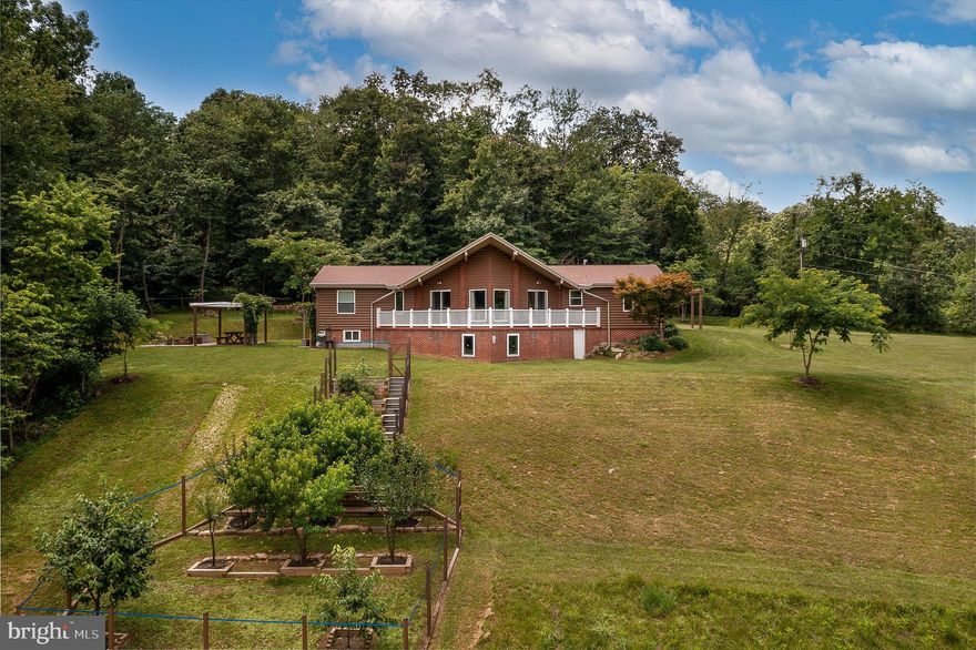 HIGHEST AND BEST OFFER DUE BY MONDAY, JULY 17TH, 5:00 PM      Just Like New!   CACAPON RIVER FRONTAGE - Perfect for an Air B&B!   This home has been totally remodeled in 2013.   Enter into the open concept space with a large Kitchen - Dining Room.   Kitchen has new cabinets, granite countertop, range, refrigerator, dishwasher and microwave.  Living room has cathedral beamed ceiling, brick wood burning fireplace and large windows over looking the property, mountains and the Cacapon River (winter view).   Large Primary Bedroom and Office.   All with hardwood floors, central air and heat.  The lower level has 2 additional Bedrooms, plus a 4th Bonus room, full bath, large family room with another brick wood burning fireplace, Sauna, wet bar, and laundry room.   Additional features include:  alarm system, COMCAST INTERNET, 1 car garage, water conditioner, multiple fruit trees and raised beds for flowers or vegetables.   Fire ring and patio's to relax or entertain.  PLUS your own 1200' of frontage along the sparkling Cacapon River (Home is not in the flood plain).
