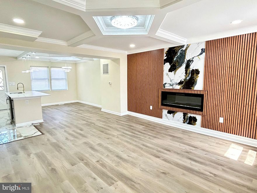 Welcome to this charmingly renovated Baltimore home situated in the sought after New Northwood neighborhood! You are sure to be blown away by the attention to detail paired with the modern elegance radiating from floor to ceiling. You are greeted with an airy open floor plan as you enter the living room, featuring stylishly designed coffered ceilings and a sleek fireplace insert nestled in the custom accent wall. The spacious living room flows seamlessly into the dining area, perfect for entertaining or enjoying a meal. The bright dining area opens up to the show stopping gourmet kitchen, which offers an expansive quartz island, new stainless steel appliances, custom cabinetry, and luxurious gold accents. Off of the kitchen, you can access the rear yard which includes ample space for creating your own private oasis! Upper level features three generously sized carpeted bedrooms with a luxe upgraded bathroom. The fully finished lower level includes a cozy fourth bedroom in addition to a contemporary full bath, laundry, and access to the rear yard. Come experience the boundless charm and allure this home has to offer!