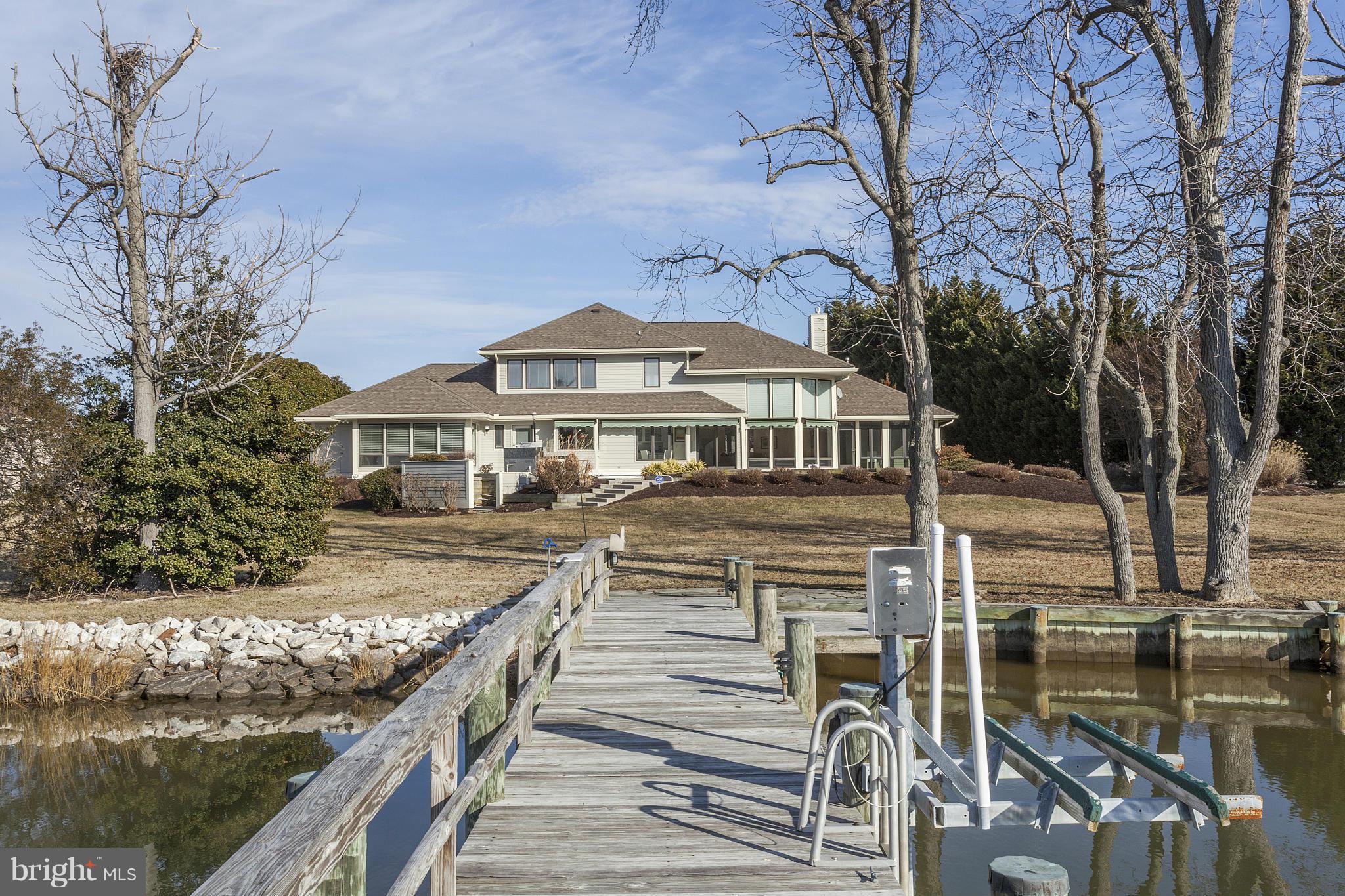 Spectacular sun-bathed waterfront property located in Cove Creek. Featuring golf, tennis, club house and deep water marina. This property affords a private setting on almost 2 acres, with pool and private dock. Contemporary interior with new custom master bath, loft easily converted to 4th Bedroom. Updates throughout. 1st exit over Bay Bridge, easy commute to Annapolis and DC area.
