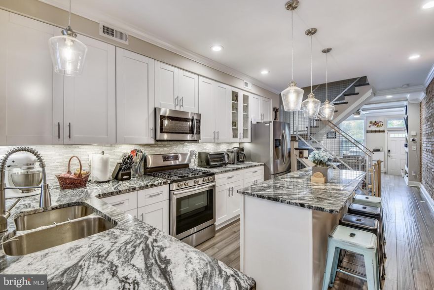 Incredible, newly renovated (2019), 4 bedroom, 3.5 bathroom with finished basement, rooftop deck, and fantastic water views located on one of the most desirable streets in Locust Point! This custom- built dream home boasts impeccable attention to detail-perfectly melding old world Baltimore charm with slick modern industrial finishes. Enter through the living room and find handscraped wide plank hardwood floors, coffered ceilings, and a sleek electric fireplace. The heart- of-home kitchen is gorgeous with white cabinets, oversized island, gas range, stainless appliances and the most stunning granite on the planet. The kitchen leads directly into the large dining area with dual pantries and a convenient 1/2 bath. Climb the custom staircase to the 2nd floor and find 2 large bedrooms, a bonus space that would make a great playroom, office or reading nook, and a gorgeous full bath with tub/shower combo and double vanities. The 3rd floor features a 4th bedroom and laundry room as well as the master bedroom with a bay window that frames exceptional city and water views, a gigantic walk in closet, and an incredible bathroom that could be featured on the pages of a design magazine. Travel up one more level and impress your friends on the full length rooftop deck with teak and turf outdoor flooring that is as functional as it is visually appealing and offers the best water and downtown skyline views on the whole peninsula! The basement is fully finished with a bonus room and full bathroom, as well as storage space. It would make a perfect home office, guest room or entertainment space. Also enjoy the convenience of dual zone smart nest thermostats and the security of the ring security system. Lowman Street is known for having easy angled in parking, a communal parking lot, and a warm neighborly feel. It is situated only 1/4 of mile from the McHenry Row shopping center and only 2 blocks from Latrobe park and Francis Scott Key School. Locust Point has become one of Baltimore City's most desirable neighborhoods- known as a quiet community surrounded by water but full of life and charm. There are quaint restaurants, excellent parks, sports fields, playgrounds, a dog park, Fort McHenry National Monument, waterfront promenade and offers free public transportation including the Charm City Circulator and Baltimore Water Taxi. Locust Point is home to major employers such as Under Armour, is close to  the University of Maryland, Johns Hopkins, Downtown Baltimore, and I95! Pets considered on case by case basis. View Virtual tour link for interactive floorplans!