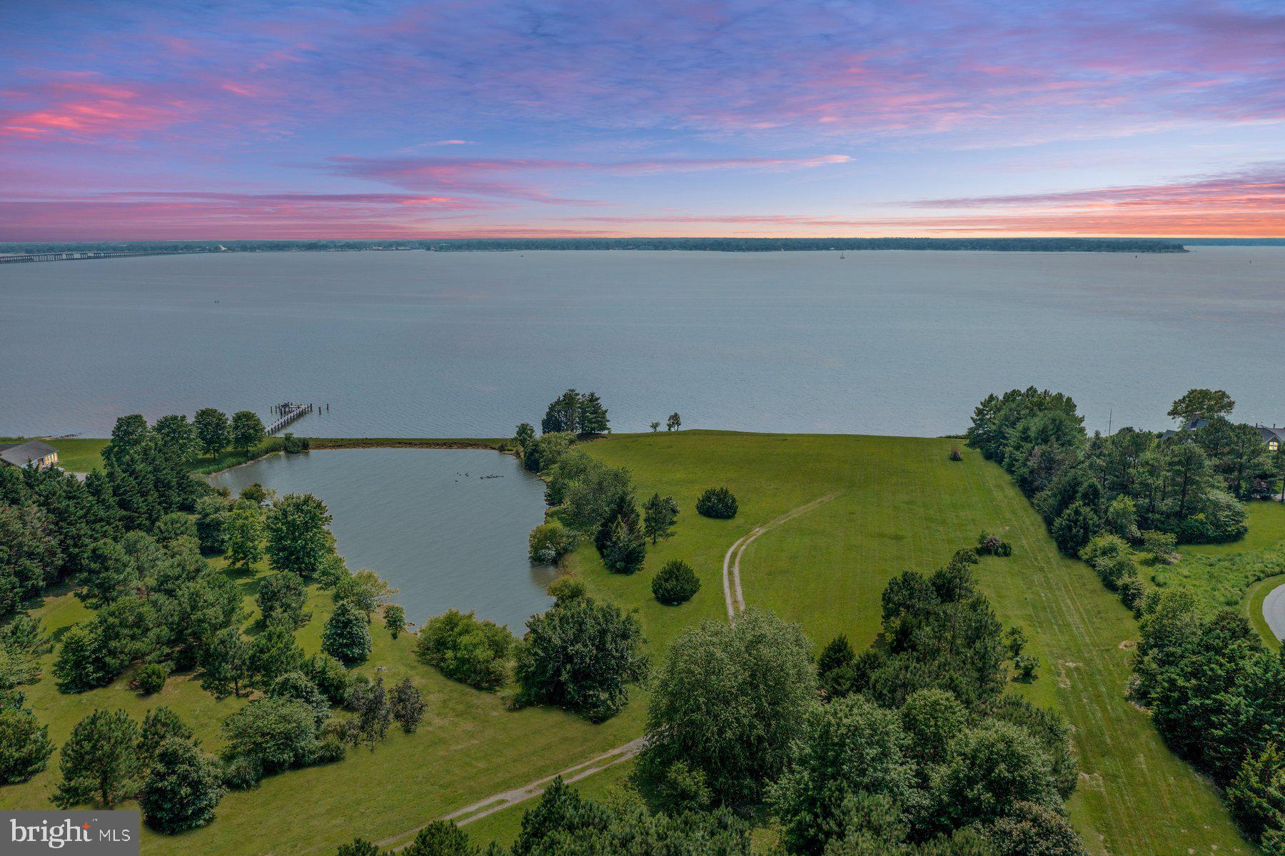 Unrivaled Waterfront Estate Opportunity: 10.88 Acres on the Choptank River!
Seize an extraordinary chance to create your dream compound on this breathtaking 10.88-acre premium waterfront lot, boasting an impressive 600 feet of rip-rapped shoreline along the majestic Choptank River. This is more than just land; it's a canvas for an unparalleled lifestyle.
This exceptional property comes with the immense advantage of previously permitted plans for a magnificent 2-story, 6,220 square ft custom home featuring 6 bedrooms with a full basement, an attached 1,200 square foot, 3-bay garage, a luxurious 1,600 square foot lanai overtop an in-ground pool. Complementing this grand residence are approvals for a substantial barn complete with a 2-bedroom apartment overhead – ideal for guests, staff, or multi-generational living.
Beyond the riverfront, discover your private oasis: including a sprawling 2.5-acre pond, perfect for serene kayaking, canoeing, or leisurely fishing expeditions. Imagine waking to tranquil water views and endless recreational possibilities right outside your door.
The new owner will reap the benefits of extensive legwork already completed, including permitting, architectural plans, SDA approvals, and more. Choose from two distinct architectural home designs, complete with detailed building plans and firms ready to bring your vision to life!
This home is strategically situated just minutes off of Route 50, providing easy access to numerous convenience shopping centers within a short drive. Imagine enjoying the coveted firework show at Green Marsh Park from the comfort of your own backyard, along with countless other boat races and events that grace the Choptank River yearly.
Embrace the ultimate waterfront living experience. This rare offering provides the privacy, scale, and ready-to-build potential to bring your most ambitious vision to life on one of the Choptank River's finest lots. Don't miss this truly unique opportunity!