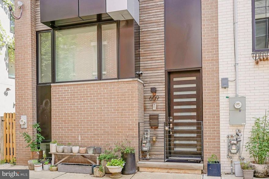 Welcome to this custom-built, 19-foot-wide masterpiece in the vibrant heart of Bella Vista, where luxury meets convenience in one of Philadelphia’s most desirable neighborhoods. This home stands out not only for its sophisticated design and high-end finishes but also for its exceptional width, offering a rare and spacious living experience in the city. With years remaining on the tax abatement and the Seller offering one year of prepaid parking at a nearby garage, this residence is the epitome of refined city living.

As you step inside, the expansive 19-foot-wide open-concept living area immediately impresses, providing a sense of space and light that is rarely found in urban homes. Perfectly designed for both entertaining and everyday comfort, this home is fully wired for top-tier entertainment and sound, ensuring every moment spent here is enjoyable. The finished walk-out basement, complete with a full bathroom, offers flexible space that can serve as a guest suite, home office, or recreation room.

Culinary enthusiasts will fall in love with the kitchen, featuring abundant storage, sleek Corian countertops, and premium appliances. This space is as functional as it is stylish, making it the heart of the home.

The residence offers three generously sized bedrooms, with two en suite bedrooms that provide privacy and comfort. The crowning glory is the top-floor primary suite, a true retreat featuring a spacious walk-in closet and a spa-like bathroom designed for relaxation. Adding to the home’s convenience, a washer and dryer are thoughtfully located on the second level, making laundry day effortless.

Outdoor living is equally impressive, with three distinct spaces to enjoy. From the tranquil enclosed yard accessible from the walk-out basement to the serene balcony off the living room, and finally, the expansive roof deck with stunning 360-degree views of the Philadelphia skyline. The roof deck is an entertainer’s dream, complete with a wet bar and a convenient half bathroom, perfect for hosting gatherings under the stars.

Location is everything, and this home delivers with its prime spot directly across from Whole Foods and just minutes from CVS Pharmacy, Palumbo Playground, and a variety of shopping and dining options. Here, luxury living meets unbeatable accessibility in one of Philadelphia’s most sought-after neighborhoods.