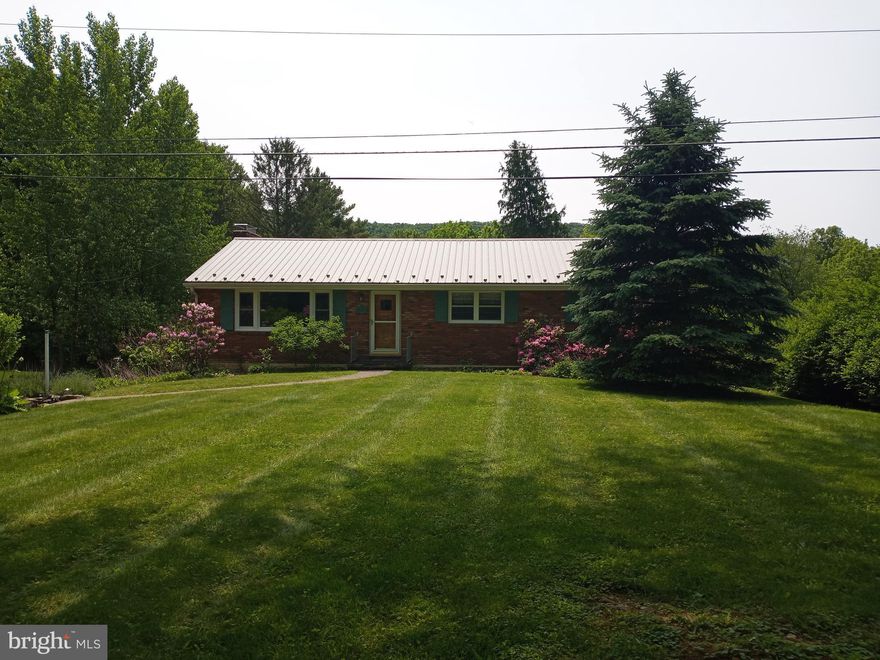 What a gem!  Come see this sturdy all brick rancher located just 5 miles from State College and only .7 of a mile from the square in Boalsburg.  Nestled on a beautiful level .68 of an acre lot and boasting hardwood floors, a stone fireplace encased with knotty pine shelves and cabinets and spacious rooms on the main level, plus a lower level featuring a large Rec/Family room and a number of smaller rooms suitable for an office, workshop or hobby areas, plus an unfinished full bath affording plenty of room for work or play.  In addition, there is a detached 19x24 outbuilding that was previously a fully functional woodworking machine shop, while in need of some repair, offers opportunity for many uses.  To top it off, enjoy those quiet summer evenings overseeing the expansive rear yard and watching your garden grow.  Great Location!  Great House! Great Price!  Property being conveyed "as is".