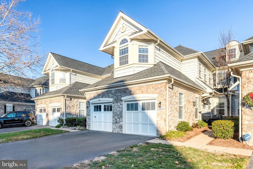 Welcome home to Belmont Bay Villas! Ideally positioned in a premier location within one of Northern Virginia's most sought-after waterfront communities, this stunning residence offers the ultimate experience. Freshly painted with new doors, trim, and hardware throughout (2025), this move-in ready home is a true retreat that combines modern elegance with the resort-style amenities of waterfront community living. Step inside to discover an inviting and open floorplan bathed in natural light, with luxury vinyl plank flooring flowing throughout the main living spaces. Inside the  gorgeously renovated kitchen (2025) you’ll find bright, refreshed cabinetry with stylish under-cabinet lighting, gleaming granite countertops, chic subway tile backsplash, brand new stainless steel appliances including a gas range, and a generous center island perfect for meal preparation and entertaining. The light-filled living room features an electric fireplace with custom built-in entertainment center, while the adjacent dining area offers the perfect space for gatherings and effortless entertaining. Retreat to the generously sized primary suite, showcasing soaring vaulted ceilings with a dramatic arched window, plus a luxuriously updated en-suite bathroom (2025) featuring a dual vanity with modern no-fog mirrors, stylishly tiled shower, and relaxing soaking tub. Three additional well-appointed bedrooms and a beautifully updated hall bathroom provide versatility for family, guests, or home office needs, while the convenient laundry room with newer washer and dryer (2020) adds everyday ease. Step outside to your private deck with serene wooded views overlooking protected non-buildable green space, accessible from both the living room and primary suite, creating an ideal indoor-outdoor flow for relaxation and entertaining. Parking is a breeze with a one-car garage featuring ample storage (2025) and a private driveway, plus community parking for visitors. Additional peace of mind comes with the updated HVAC system (2017) and water heater (2017), both professionally maintained for reliability and efficiency. Residents of Belmont Bay enjoy an unparalleled lifestyle with access to a full suite of amenities including a picturesque marina with boating access, tennis and basketball courts, an outdoor pool, clubhouse, playground, scenic trails, and beautifully maintained common spaces with professional landscaping. All of this, just minutes to Wegmans, Aldi, Walmart, Stonebridge at Potomac Town Center, Potomac Mills, Veterans Memorial Park, Occoquan Bay National Wildlife Refuge, Mason Neck State Park, and the charming shops and restaurants of Historic Occoquan. Nature lovers will appreciate the proximity to Occoquan Bay National Wildlife Refuge and Mason Neck State Park, while commuters will enjoy seamless access to Route 1, I-95, Prince William Parkway, and Ox Road, with the VRE Woodbridge station just one mile away for easy commuting to DC. This is more than just a home - it's a lifestyle. Don't miss this opportunity to own one of Belmont Bay's finest residences! Start the new year in your beautiful new home - schedule a private tour today!