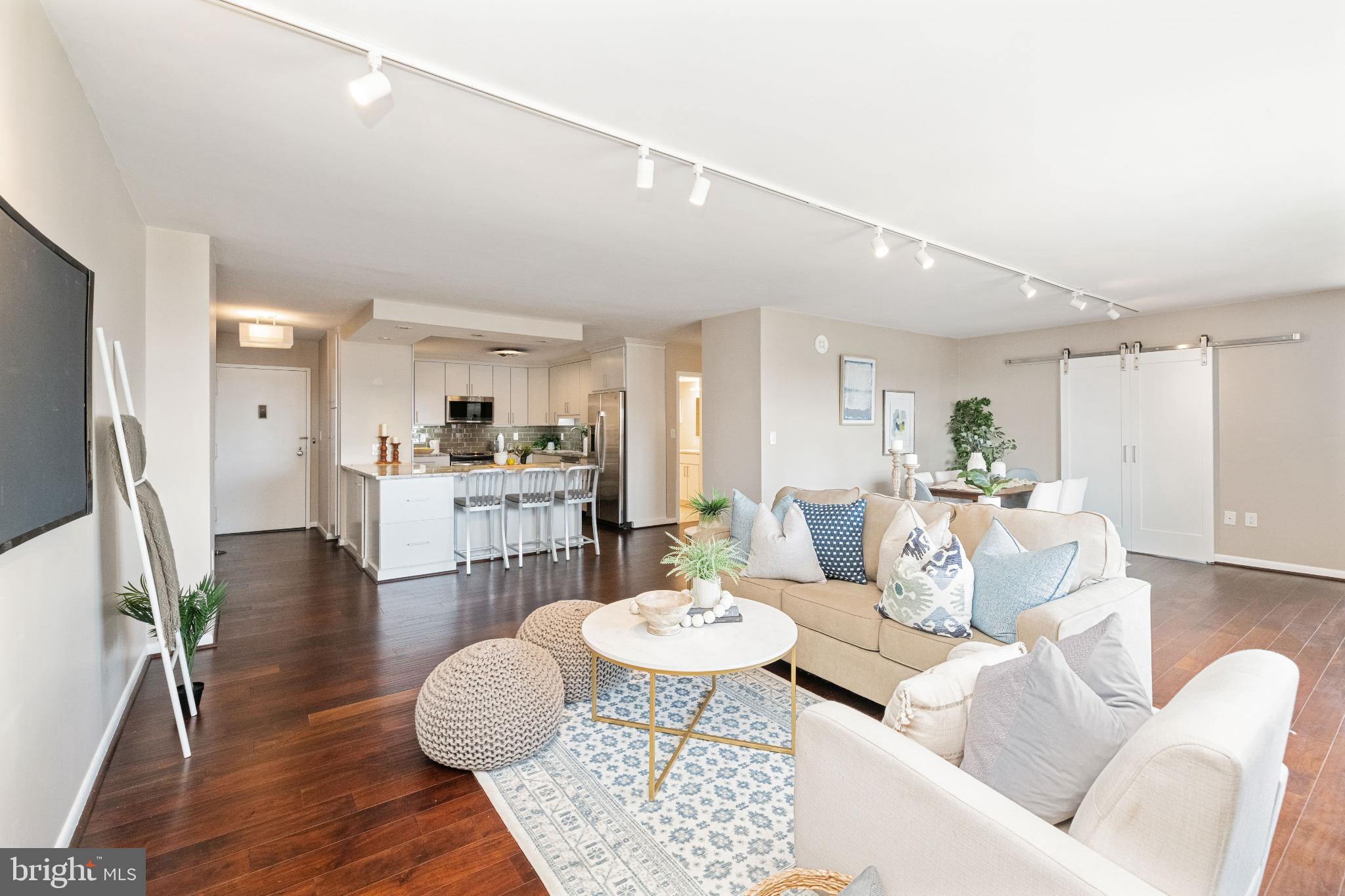 Nestled in the prestigious Ridgley building of Towson, this exquisite 2-bedroom, 2-bathroom unit offers a harmonious blend of luxury and comfort. Step inside to discover an open floor plan that seamlessly connects the gourmet kitchen and inviting living area, perfect for both entertaining and everyday living. The kitchen boasts upgraded countertops and stainless steel appliances, including a built-in microwave and range, ensuring a delightful culinary experience. Retreat to the primary suite, featuring a spa-like bathroom complete with a soaking tub and stall shower, providing a serene escape after a long day. Elegant wood floors and recessed lighting throughout enhance the warm ambiance, while ceiling fans add a touch of comfort. Enjoy the convenience of in-unit laundry with a stacked washer and dryer, and take advantage of the building's exceptional amenities, including a heated saltwater pool, fitness center, and clubhouse. With three assigned parking spaces in a secure garage, your peace of mind is assured. The community's well-maintained grounds and custodial services reflect a commitment to quality living. Experience the exclusive lifestyle that comes with residing in this remarkable high-rise, where every detail has been thoughtfully curated for your enjoyment. Embrace the perfect blend of luxury and comfort in this stunning Towson residence.