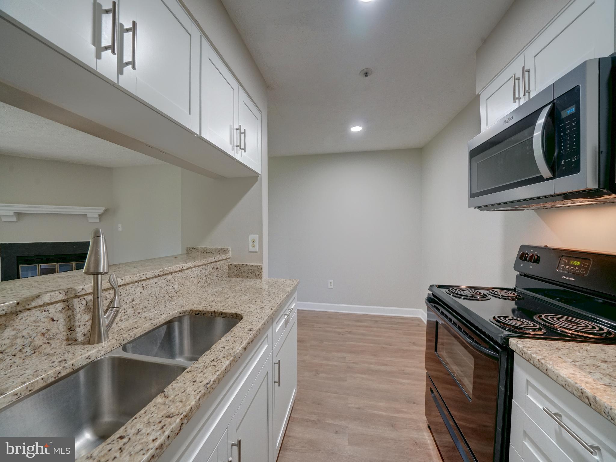 Welcome home to this lovely 2 Bedroom, 2 Full Bath flat walk out level condo with many updates! It's available now. Recent upgrades in the kitchen are cabinetry, refrigerator, built in microwave, beautiful granite counters, high gooseneck faucet, under mount sink & new recessed lighting. This kitchen bright and light. The baths have updated toilets and the bathtubs were reglazed 10/21. Luxury vinyl plank floors run throughout which makes cleaning a breeze. The dishwasher & fresh paint all updated in the past few years also. The Living Room has a beautiful newer fireplace mantle (fireplace is to be viewed but not used). Step out the French doors to the patio which overlooks open space. The primary bedroom has an en-suite full bath, walk in closet, and 3 windows for plenty of natural light. A full size washer & dryer are in the hall between bedrooms. The second bedroom is a nice size and the 2nd/hall bath offers an updated toilet, closet and tub/shower combo.
Tenant receives 2 parking passes for parking lot, and there is plenty of visitor parking. There is additional parking on Green Field Rd also. No smoking or vaping, small pets are considered case by case. Good credit, bills paid on time, insurance required. You can stroll to the grocery, restaurants, Ho Co library, 50+ Center, Patapsco Park. This is convenient to major commuter routes I-95, Rt 295, 100, 695, MARC Train, BWI Airport, NSA, DOD, Ft Meade, UMBC, and not far from JHUAPL. Centrally located between Baltimore and Washington. See what Howard County living offers. Have your agent schedule a tour today!