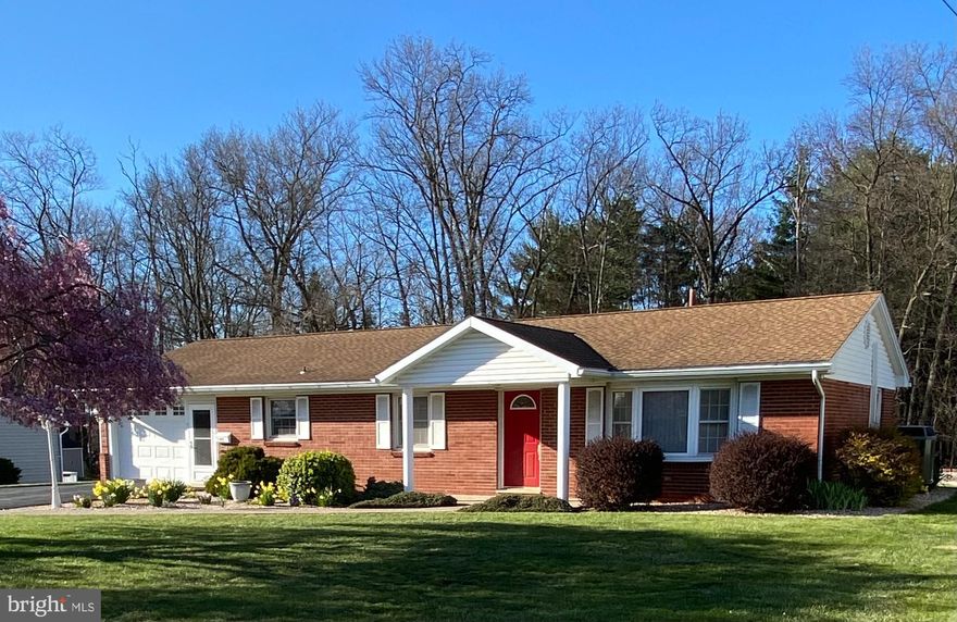 This immaculate brick ranch is move in ready and has so many possibilities and options.   Bright home with hardwood floors, fireplace, replacement windows, on quiet street just blocks from the university.   Features mini split A/C heat with backup electric and radiant ceiling heat, Full bath as well as 1/2 bath en suite, mini split in garage area.  Additional room with mini split and hookup for woodstove provides options for additional bedroom or living room.  Property also has a large shed and oversized detached two car garage with hookup for woodstove.    Outside provides serene patio and a stoned area for camper parking with electric hookup.  Full basement with interior and outside access has setup and electrical for woodshop.