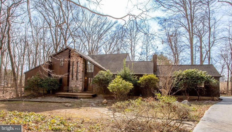 Spectacular private setting and a one-of-a-kind contemporary, custom built house
awaits a discerning buyer who wants a serene retreat, privacy, enjoys the beauty of
nature and a great location, and appreciates the quality of craftsmanship and
architectural details. Down a long driveway with an expansive front lawn is a circular
driveway that brings you to the house surrounded by trees and natural beauty. Step
inside to a soaring height foyer with dramatic windows and staircase. In front of you is a
large dining room with Craftsman-style Pella retractable screen windows. The eat-in
kitchen has custom cherry cabinetry that include cabinets set into the wall. Quartz
countertops, glass backsplash, 5-burner cooktop in a two-level island with seating, and
two wall ovens complete this beautiful, working kitchen and casual dining area. The
spacious great room entered through French doors is a showstopper with a stone floor-to-ceiling woodburning fireplace, cherry flooring, exceptional wood detailing and doors to the patio. The primary bedroom suite is on this level and has two closets plus a walk-in closet and an ensuite bath with soaking tub, and a  door to a private separate deck. There is also an office, half bath, and adjoining the kitchen is a den/library, and laundry room. On the second floor are two bedrooms and a hall bathroom. And then there’s the mostly
finished walk-out lower level. There is plenty of storage space but this level also has an
additional bedroom, a huge open recreation space with wet bar and refrigerator, a double closet, a full bath with jetted tub, and a door outside to the private patio area. A 2-car garage with high ceiling also has plenty of storage space with access into the kitchen. This special home and property is the best of inside and outside daily comfort and gracious entertaining. Woods abound with birds, wildlife, and an ever-changing landscape of color. A path from the deck takes you to the inground swimming
pool set in a grove of evergreens.  with acceptable  offer, Seller to provide credit of $4850 for opening, cleaning and pump repairs as per pool repair quote in documents. The reduced  taxes are due to a grandfathered  Act 319 agricultural  . Truly, this a wonderful opportunity to live in a slice of paradise that is close to commuting routes to Philadelphia, Princeton, and NYC, and outstanding shops and stores, restaurants, recreation and entertainment are
nearby. Relax, eat, play, and be merry. Welcome, indeed.
Additional photos to be published tomorrow.