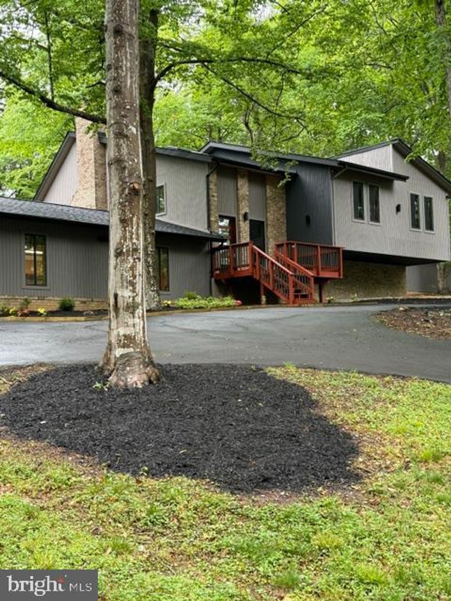UNIQUE  CONTEMPORARY ON 3+ACRES... .TOTALLY - CUSTOM -  UPDATED INSIDE AND OUT... RIGHT AROUND THE CORNER FROM  FAIRFAX COUNTY ...LONG PRIVATE DRIVEWAY LEADING TO YOUR NEW  HILL TOP RETREAT.... NO HOA...TON'S OF PARKING ..CIRCLE DRIVE ..DETACHED 3 SPACE CARPORT TYPE STRUCTURE...PLUS.. I CALL IT A PAVILLION, WITH LIGHTS , OUTLET'S...WATER  - GREAT FOR COOK OUT'S ,PARTIES ,SUMMER TIME FUN....BACKS TO INCREDIBLE WOODED SETTING THAT GOES ON AND ON...(THINK DIRT BIKE TRAILS ,HIKING, TREE HOUSE, NATURE PRESERVE FOR ANIMALS) WHOLE HOUSE GENERATOR WITH 2 LARGE PROPANE TANKS, EXTENSIVE MULTI -TIER DECKING...YOU THINK THE OUTSIDE IS NICE...WAIT TILL YOU SEE WHAT AWAITS INSIDE...DESIGNER PAINT COLORS ,WITH ACCENT WALLS THROUGHOUT...REAL HARDWOOD FLOORS -(NOT LAMINATE) - POPULAR GRAY WASHED WIDE PLANK STYLE - EXPENSIVE KITCHEN , TWO TONE CABINETS, SOFT CLOSE, UPSCALE GRANITE ,FARM SINK, OVERHEAD LIGHTED VENT - FIREPLACE WITH BUILT IN FAN FOR HEAT - WALL OF GLASS WINDOWS AND DOORS IN BACK LEADING TO A WRAP AROUND DECK - ALL BATH'S ARE TASTEFULLY DONE, NO CRAZY COLORS OR PATTERNS HERE... ALL CLOSET'S IN BEDROOMS HAVE OVER HEAD LIGHTS ,SAME AS TUB'S AND SHOWER'S ... OH, I FORGOT TO TELL YOU - NEW SKYLIGHTS ALL HAVE REMOTES TO OPEN AND CLOSE BUILT IN BLINDS... WASHER / DRYER ON BOTH LEVEL'S ...LOWER LEVEL HAS A WOODSTOVE THAT HEATS ENTIRE HOUSE, THAT VENTS UPSTAIRS....IF YOU DON'T WANT TO USE THE TRANE FURNACE... UPPER LEVEL HAS WHOLE HOUSE FAN...EXCITING LIVING ROOM WITH A BUILT IN BRICK PLANTER...SEE PICTURES...VAULTED CEILING..FAN'S AND RECESSED LIGHTS EVERYWHERE THROUGHOUT THE HOUSE...MANY HAVE BUILT IN DIMMERS...OWNER /AGENT'S CALL THIS HOME OUR ''GRAND FINALE'' IT'S THE BEST AND MOST FUN HOME WE'VE DONE...I HOPE YOU WILL THINK SO TOO!