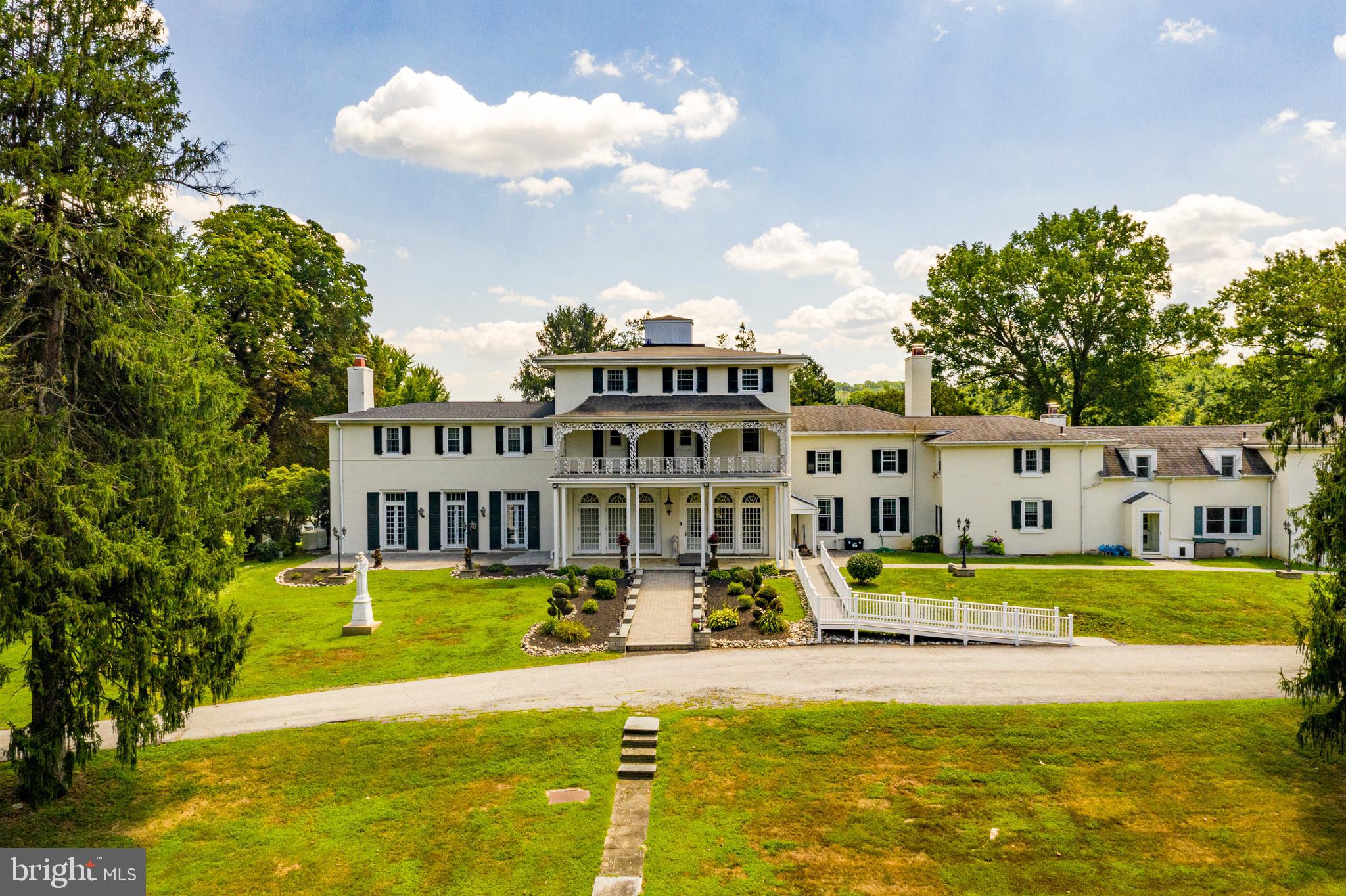 1500 Pocopson Road is a Rare Opportunity to Own an Historic and Beautiful 32 Acre Country Estate, formerly known as Padua Estate . Conveniently located between West Chester, Longwood Gardens in desirable Unionville-Chadds Ford School District. Enter into this wonderful Manor Home with exquisite charm, period details and moldings through the Formal Entrance Foyer with Dramatic Soffit Step Floating Staircase and Open Palladium Windows. The formal Living Room includes a large center fireplace with Santa Giorgio Casting, matching mirrored French doors with stained glass windows and detailed Mahogany beamed ceiling. To the right of the entrance foyer is the formal Dining Room working with Fresco neo-classic wallpaper. French doors on either side of the fireplace lead you into the Butler s Pantry to the right and Family Room with first floor master to the left. Large multi-level Giorgi kitchen with black granite counter tops, large pantry, island, prep kitchen and Mudroom. Off the kitchen is the Family Room with a gas fireplace, skylights and French doors to the terrace. From the Family Room you enter into a first floor Master Bedroom complete with tray ceiling, double closets, and bathroom with large double shower and sinks. The second floor has Dual Ensuite Master Bedrooms with balcony, an additional ensuite Bedroom, two additional Bedrooms with a jack-and -jill Bathroom and potential for an Office with an additional full bathroom. Accessing to the back stairway are two additional rooms with a full bathroom. Third floor has 3 additional Bedrooms, full bathroom and large laundry. Attached to the main house with separate access is an Apartment with 4 additional Bedrooms, 2 full Baths, Kitchen, Dining Room and Living Room. Entertain from the flagstone terrace that extends across the entire back of the house with private access from each room. Beautiful views, gardens and 2 in-ground pools one currently being used as a Koi pond. The property has two separate houses used for guests or rentals and a two car detached garage.