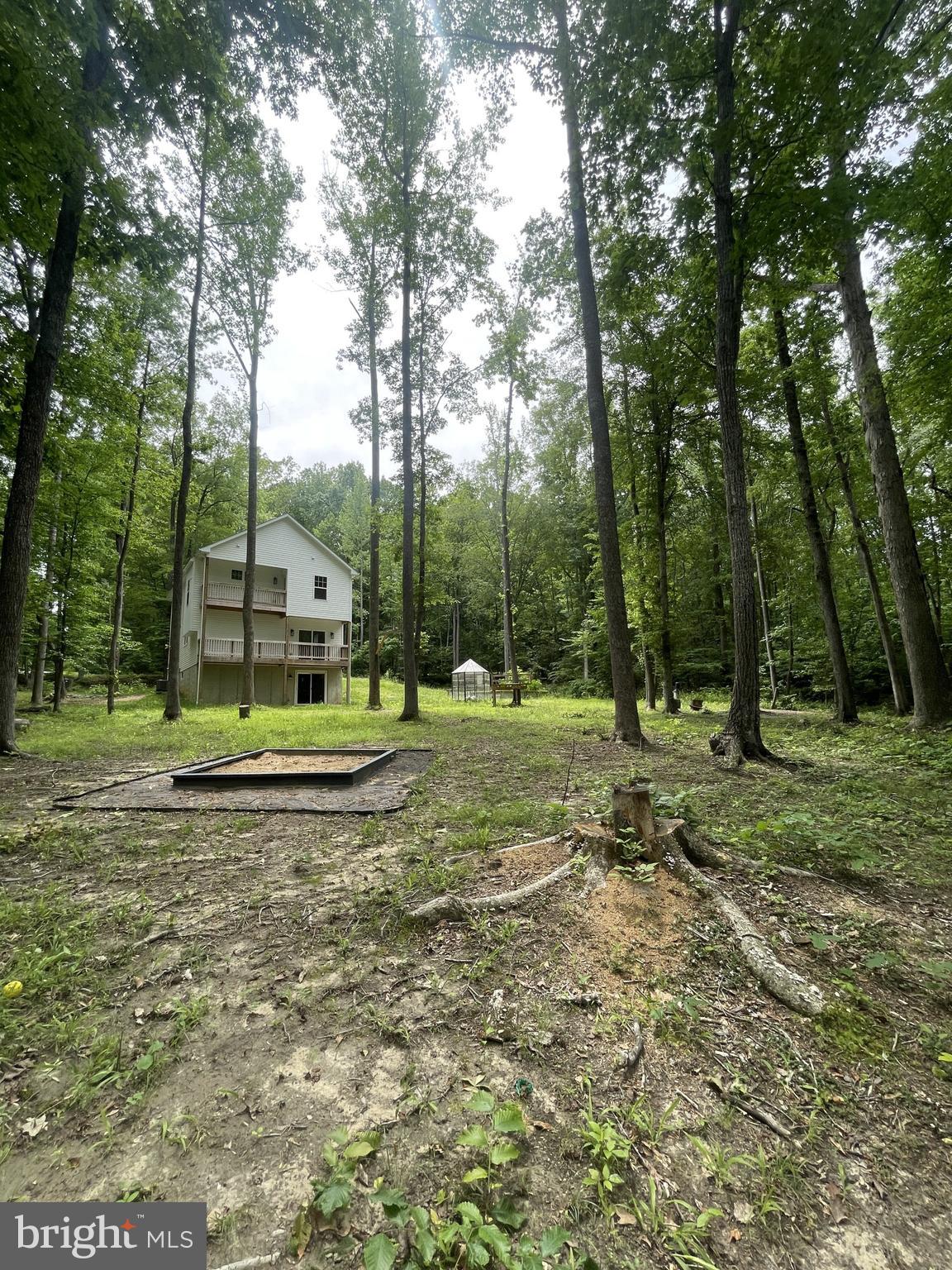 BACK TO ACTIVE!!! SELLERS WILLING TO HELP WITH RATE BUY DOWN OR CLOSING COST ASSISTANCE. Welcome home to this 2021 build located in a 10 ACRE wooded oasis and lovely neighborhood community. This home is an outdoorsmen dream, with potential for hunting, fishing and long walks on the forested trails. The owners have built lots of fun outdoor features, including a sand pit, garden boxes, greenhouse and fire pit. Inside you will find 3 bedrooms, 2.5 baths and an extra office space or flex room on the upper level. The basement has walkout level doors, and has the potential to be finished for a fourth bedroom and bathroom, plus living area. The kitchen features a large island, stainless steel appliances and granite countertops. The primary bedroom and the main living area both have decks off them to enjoy the outdoors. The home just had a whole house water filtration softener installed as well as a reverse osmosis filter hooked up in the kitchen. The septic was also previously on a service contract and has been checked within the last year. Only a few others homes in this price point near Fredericksburg for under 600 with this acreage, it's a great deal!!