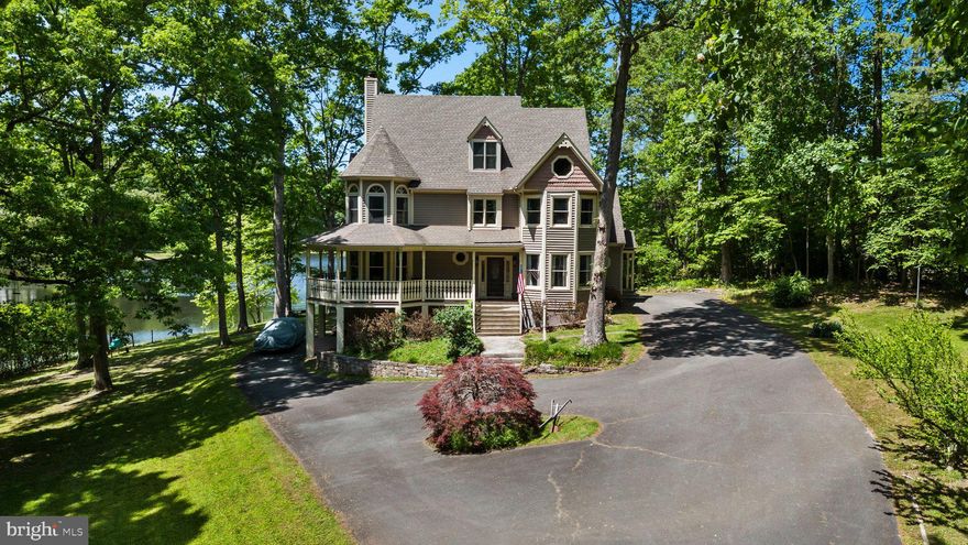 BEAUTIFUL WATERFRONT Property! Discover the perfect blend of classic charm and outdoor adventure with this unique Victorian-style home featuring stunning lake views and access. Situated on over 4.5 acres of prime waterfront property, this one-of-a-kind residence offers an idyllic retreat for those who cherish both style and nature. The high ceilings and abundant natural light in the living spaces create a warm and inviting atmosphere, perfect for entertaining or relaxing. Enjoy the convenience of the private floating dock, ideal for venturing out on your boat or fishing from your backyard. The home boasts a wrap-around porch, providing picturesque lake views from all rear rooms, and a finished walk-out basement. Inside, you'll find a formal dining room, a living room with hardwood floors, and 10' ceilings throughout. The family room seamlessly opens to a kitchen equipped with tile floors, quartz countertops, stainless steel appliances, bar seating, and a cozy breakfast nook. The master bedroom includes a walk-in closet, an en-suite master bath, and a private screened porch (and new windows!). The walk-out basement offers additional living space with a recreation area and a full bath. The screened porch with a vaulted ceiling provides breathtaking views of the lake, making it an ideal spot to unwind and enjoy the serene surroundings. Make this dream home your reality!