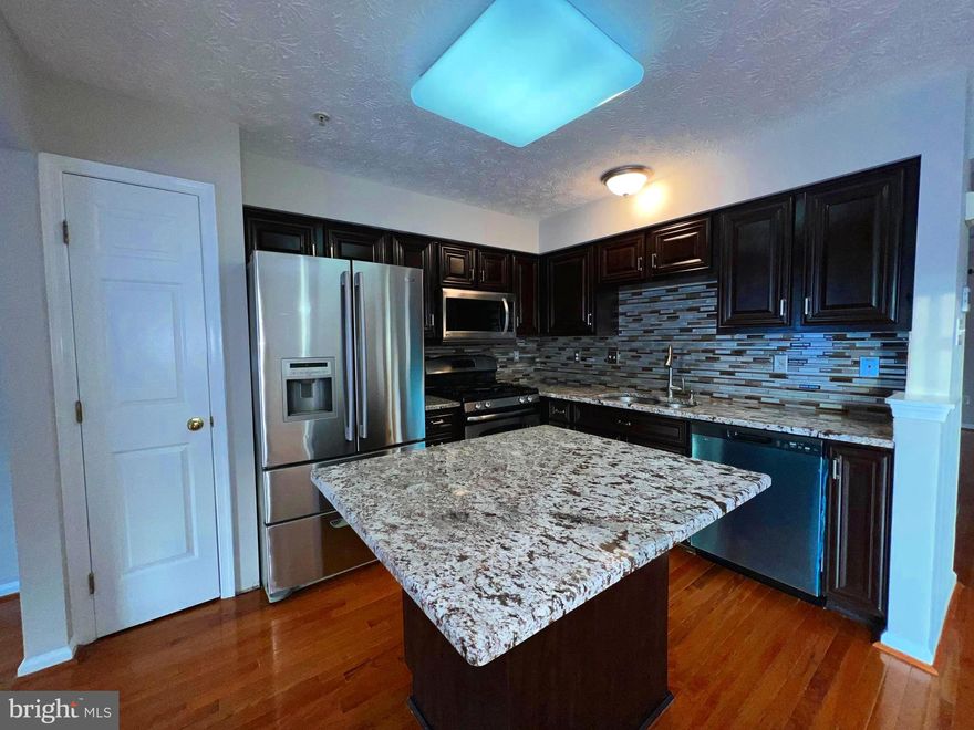 Spacious & Immaculate EOG townhouse in highly desirable neighborhood in Owings Mills now available with gorgeous hardwood floors on main level, updated kitchen with granite counter tops and island, separate dining area, Stainless Appliances, bump out off kitchen that can be used as den or family room,  walk out to  deck that opens to common area, huge finished basement with bump-out and storage area plus plumbing for an additional bathroom, primary suite with soaking tub and stand up shower, and much much more!