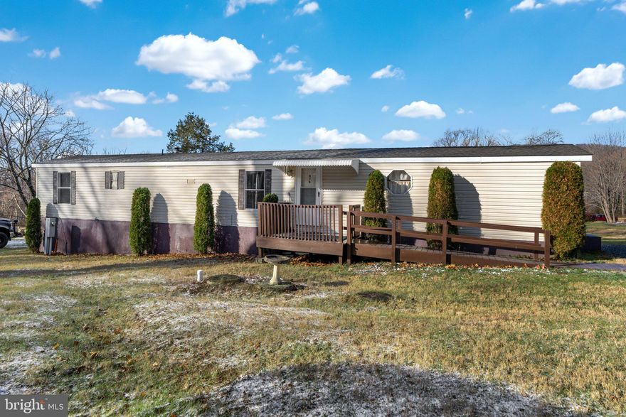 Stop paying high rent prices and own your own home!  This move-in-ready 3-bedroom 1-bath manufactured home is situated on its own .26-acre lot, offering easy, one-floor living. Recently remodeled featuring brand-new kitchen appliances, new kitchen linoleum floor, fresh paint, and new carpeting throughout, creating a clean, updated interior. The spacious layout includes a laundry area and an open flow between rooms. Outside, a large rear deck provides the perfect space for relaxation or entertaining, while the accessibility ramp and ample driveway parking for multiple cars add convenience. Low taxes, No lot rent, and the property is serviced by an on-site well and septic system makes this home very affordable.  This property is ideal for anyone seeking their own low-maintenance living, Don’t miss this opportunity—schedule your showing today!