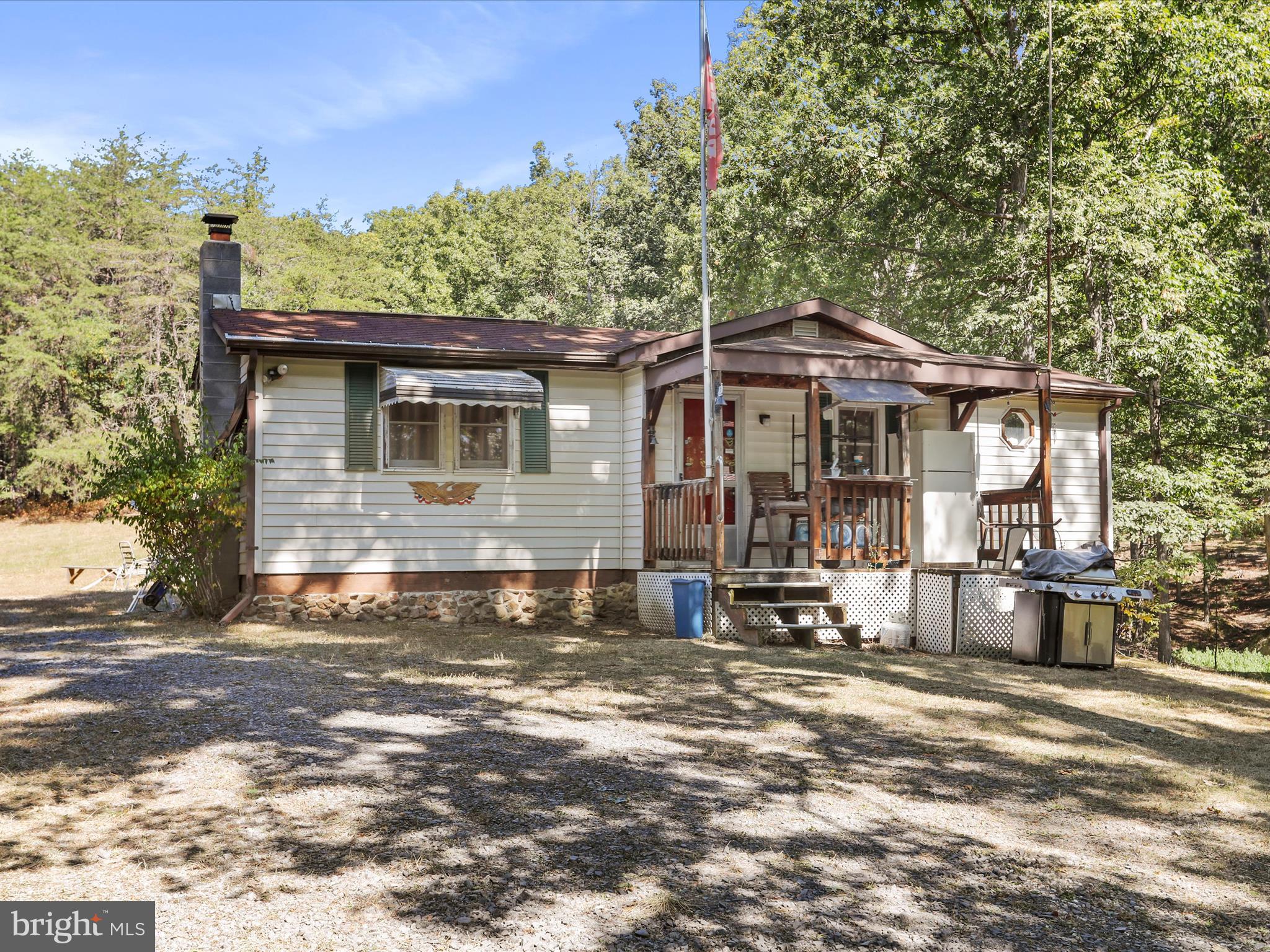 JUST IN TIME FOR THE FALL SEASON IS THIS HOME ON OVER 14 ACRES WITH WOODED ACREAGE AND A NICE YARD. THE PROPERTY BOASTS A PRIVATE POND, A SEASONAL CREEK, AND A HUNTING BUNK HOUSE WITH KITCHENETTE AND WOODSTOVE. THE MAIN HOUSE ALSO HAS A LOVELY STONE ACCENT WALL WITH IT'S OWN WOODSTOVE TO KEEP YOU WARM ON COOL NIGHTS. THE COMMUNITY OFFERS TO ITS OWNERS A PRIVATE FISHING POND AND PICNIC AREA. BRING YOUR ATVS AND GET READY TO RELAX!